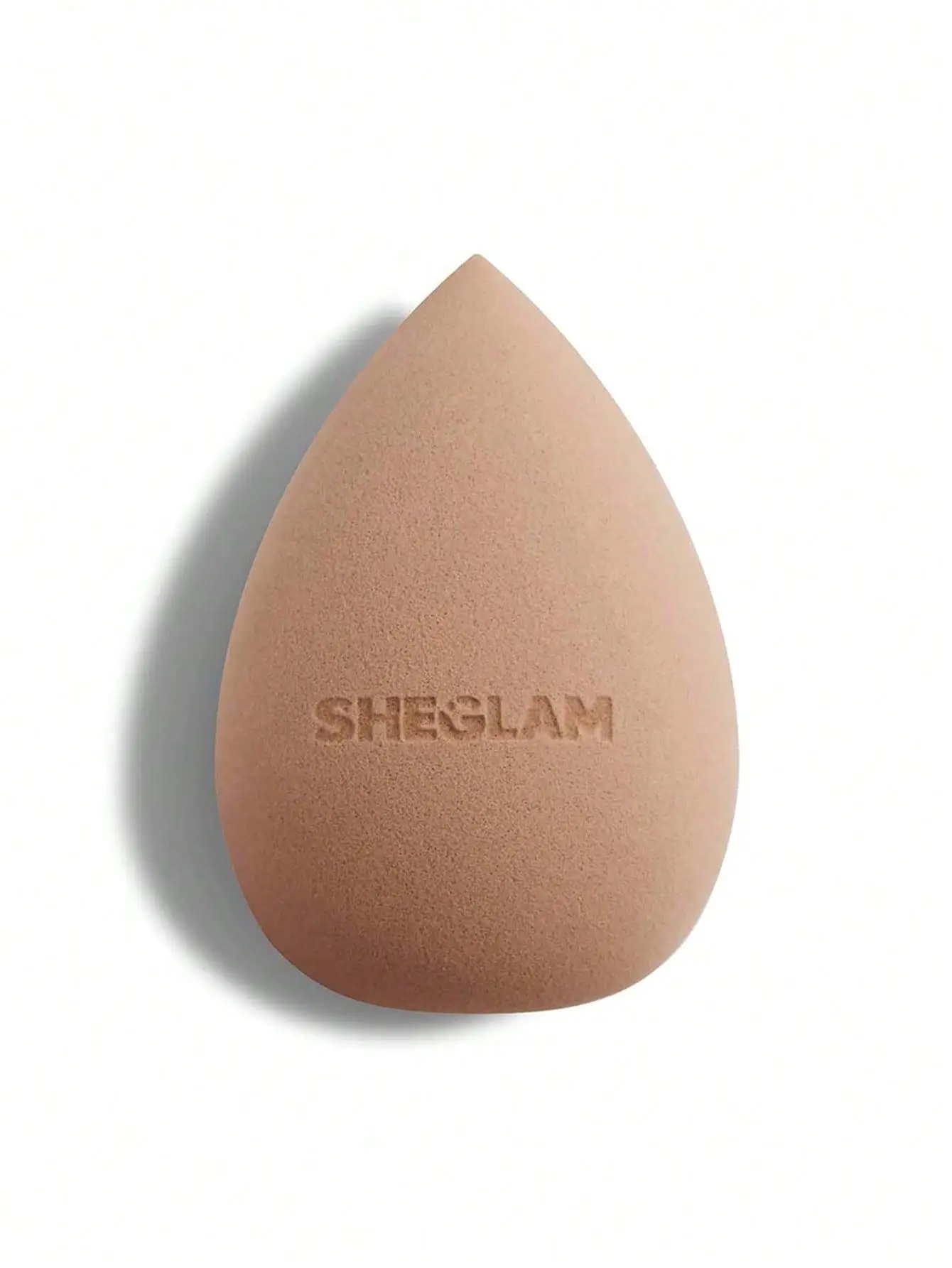Beige makeup sponge with embossed logo on white background