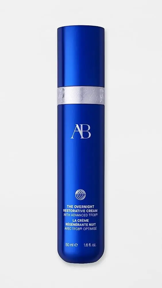 Blue cylindrical skincare bottle with silver band detailing on white background