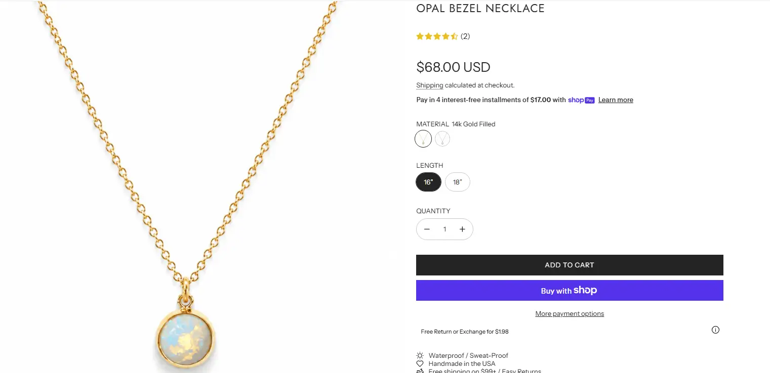 Gold chain necklace with opal bezel pendant displayed on a white background