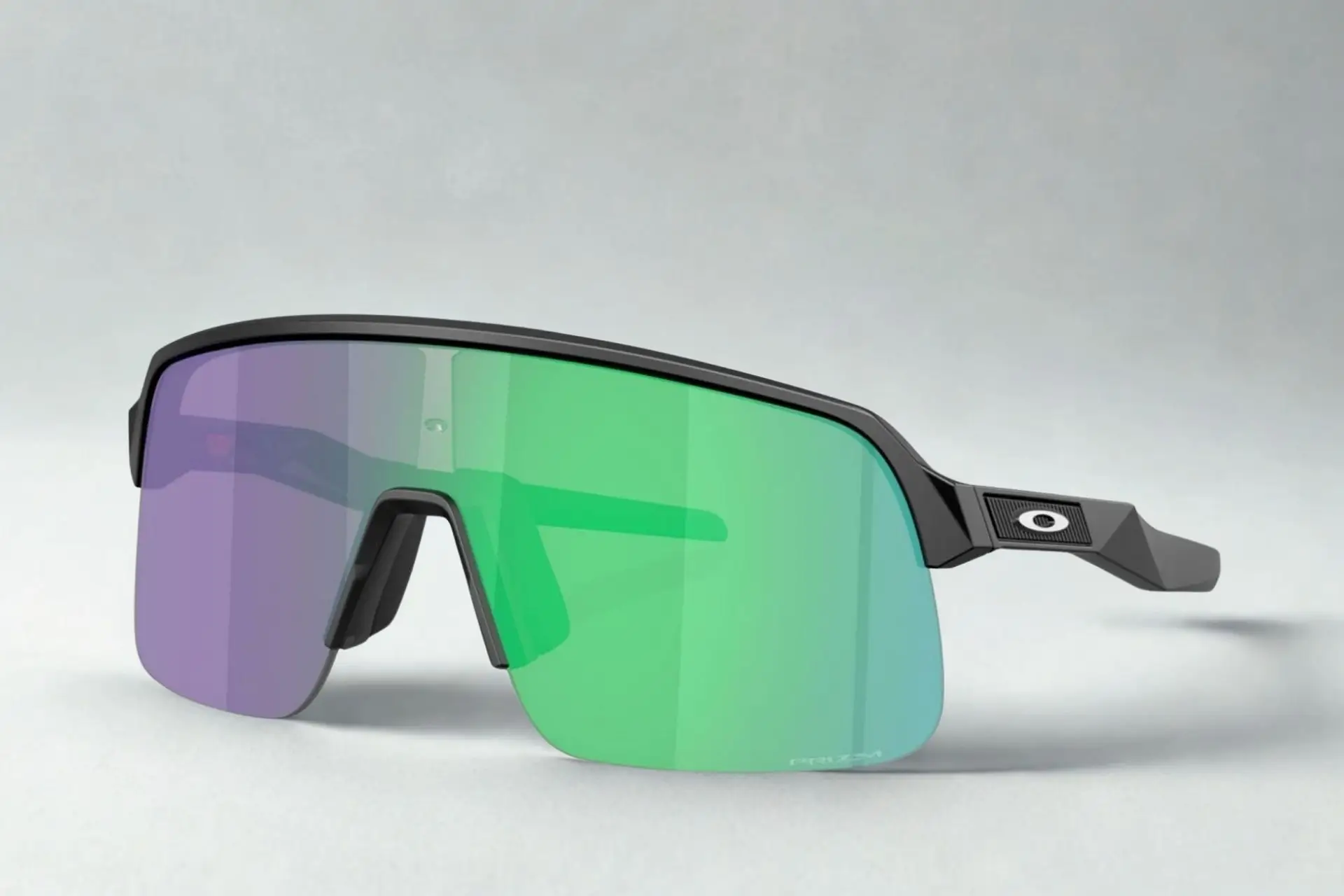 Sleek sunglasses with purple and green lenses on light grey background