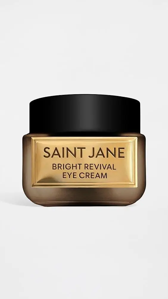 Gold and black jar of Saint Jane Bright Revival Eye Cream on white background