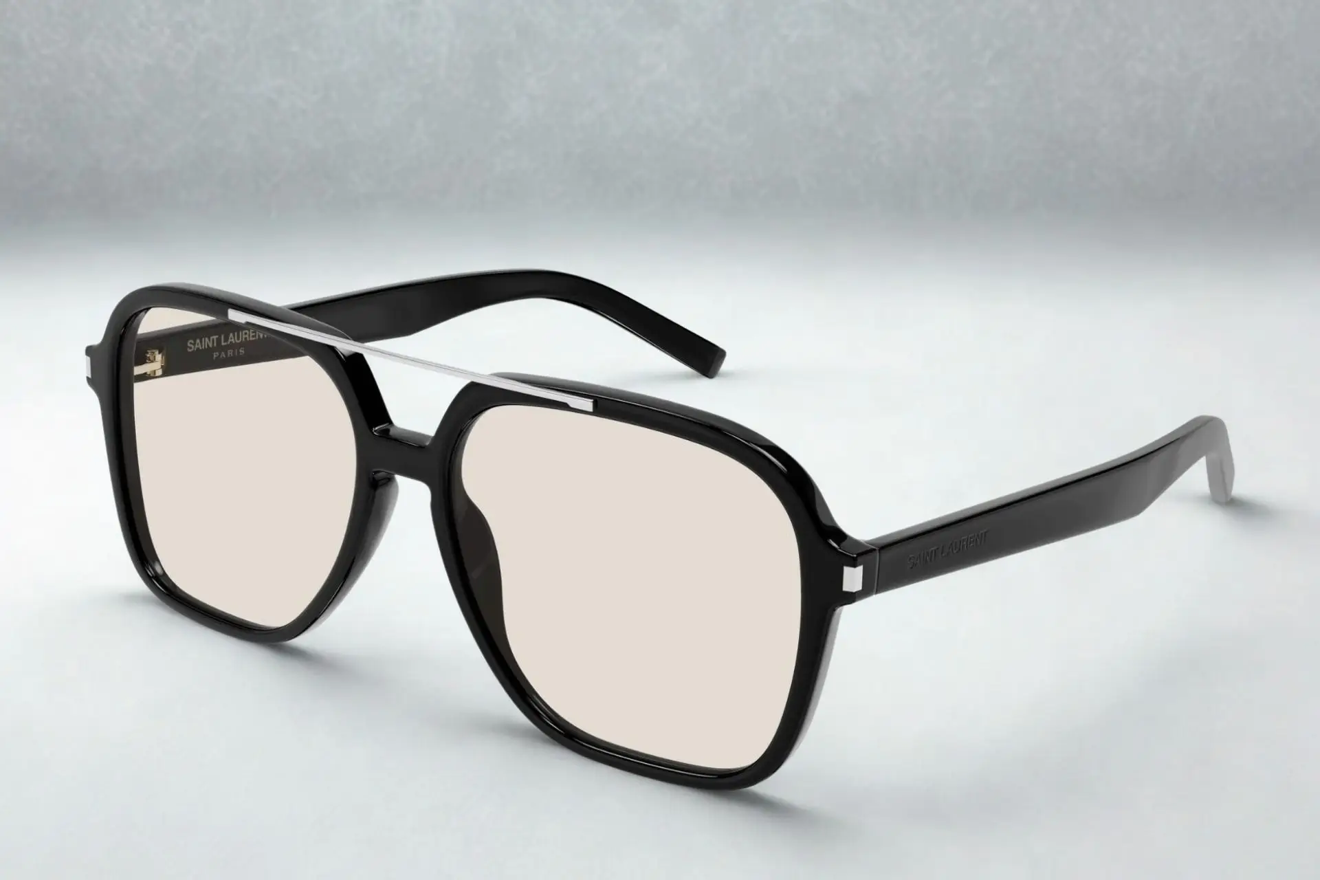 Black square-framed glasses with clear lenses on light gray surface