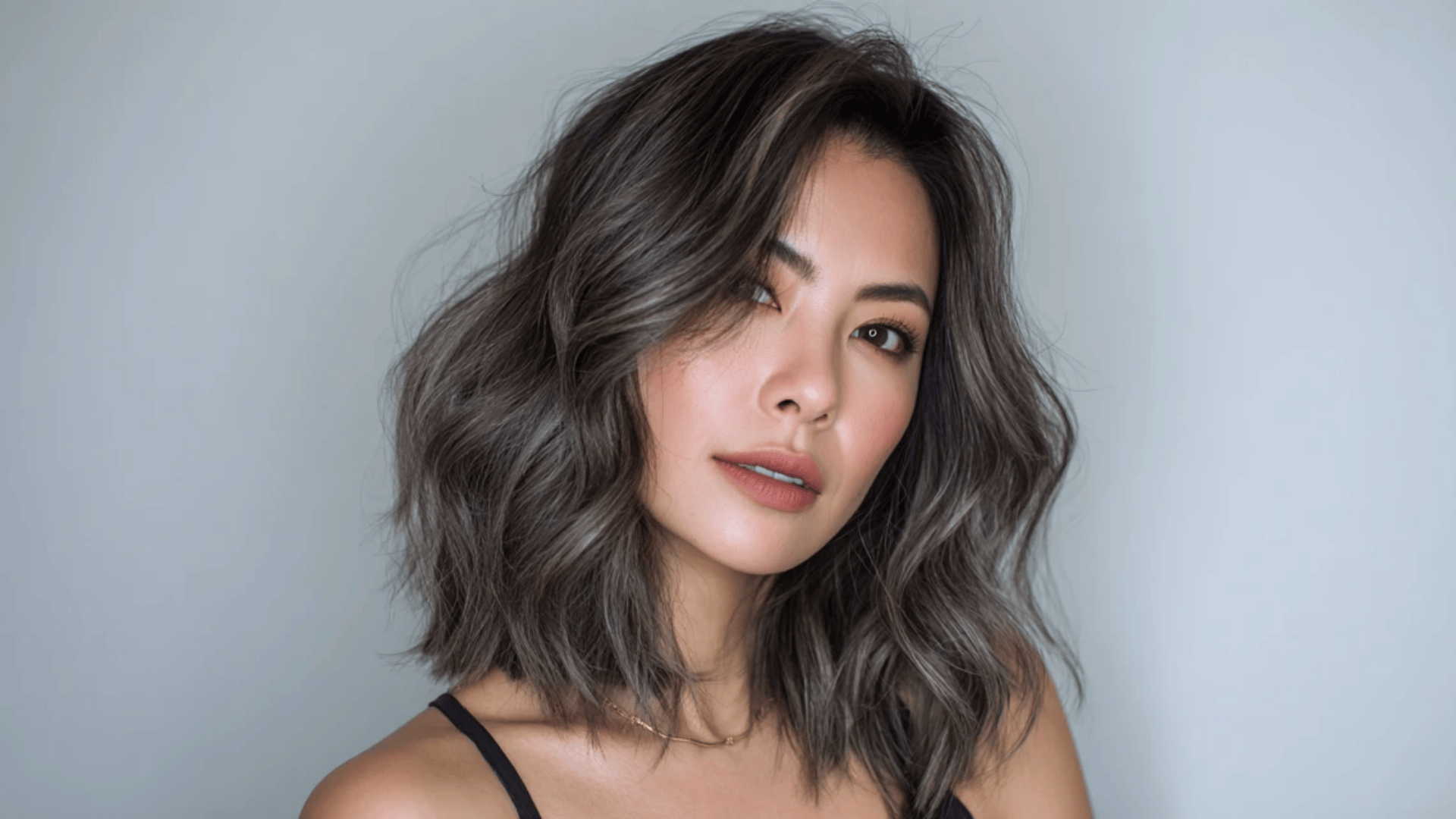 Ash brown balayage highlights adding dimension to a long bob cut