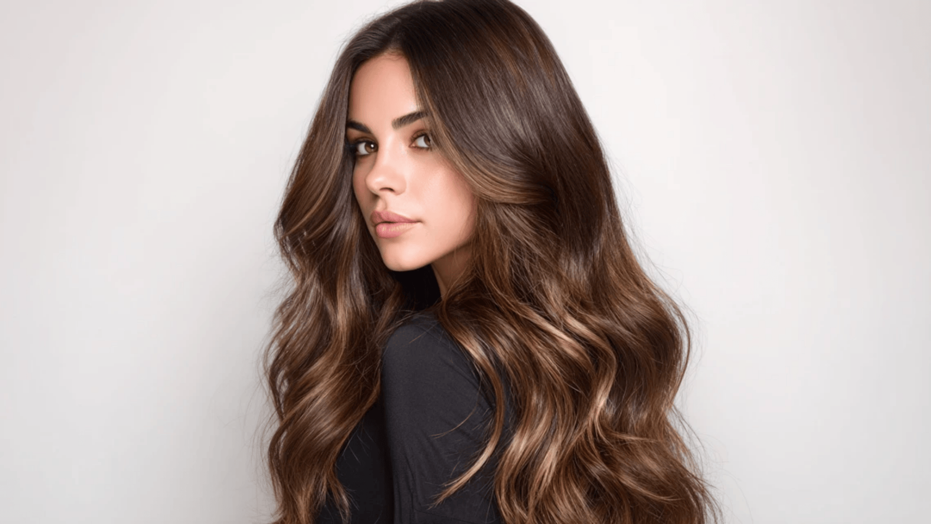 Ash blonde balayage transitioning gradually from brunette roots