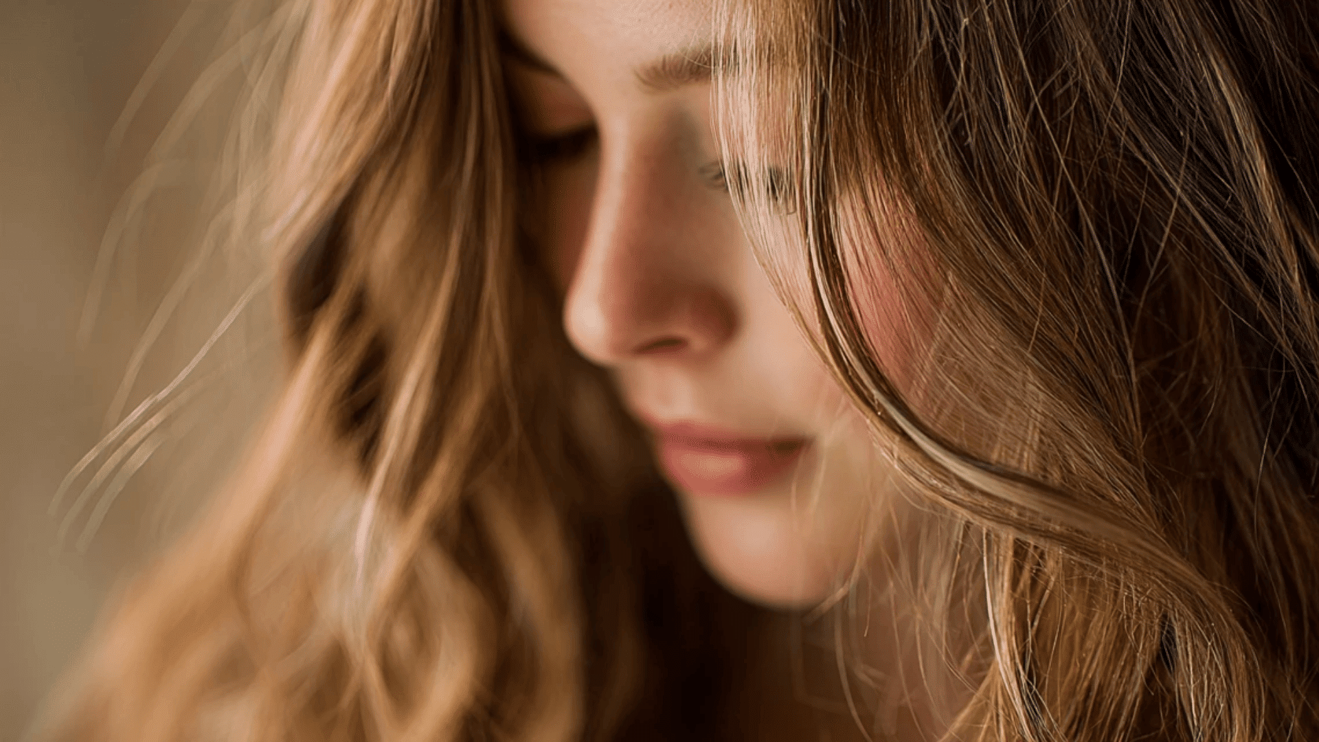 Fine ash brown babylights creating a soft, sun-kissed effect