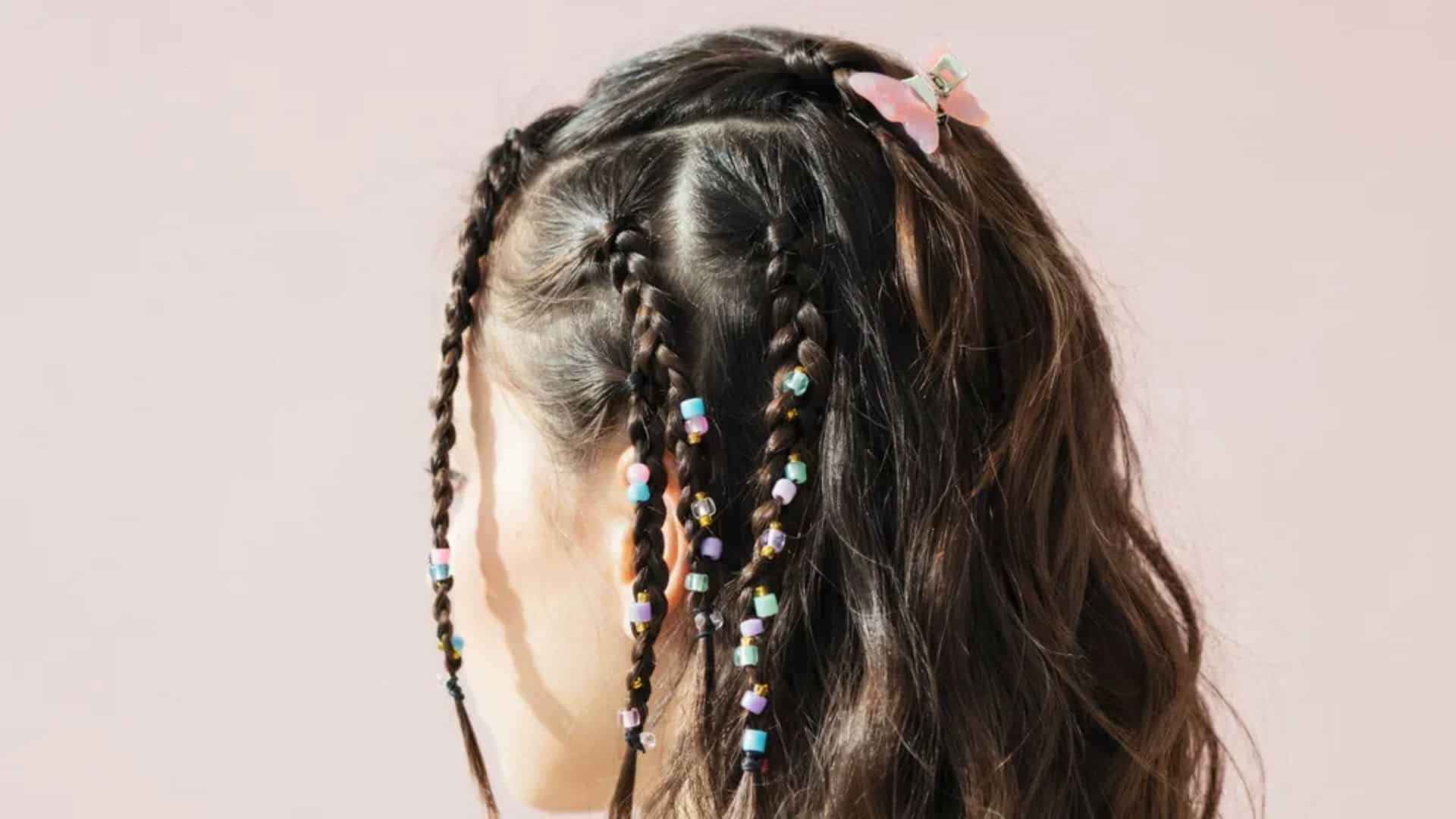 Early 2000s hairstyle with small colorful beads added to braided hair sections.