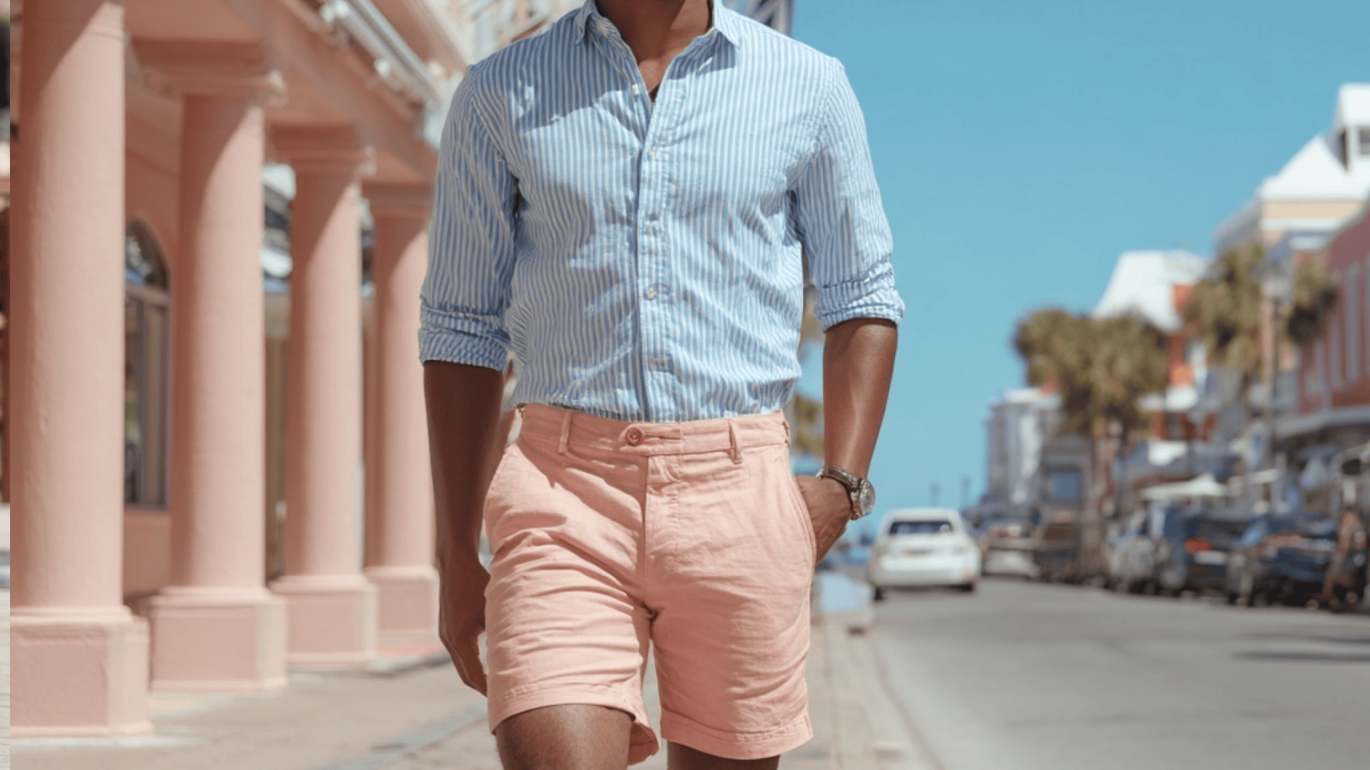 Man wearing knee length Bermuda shorts with a polo shirt for a polished casual look.
