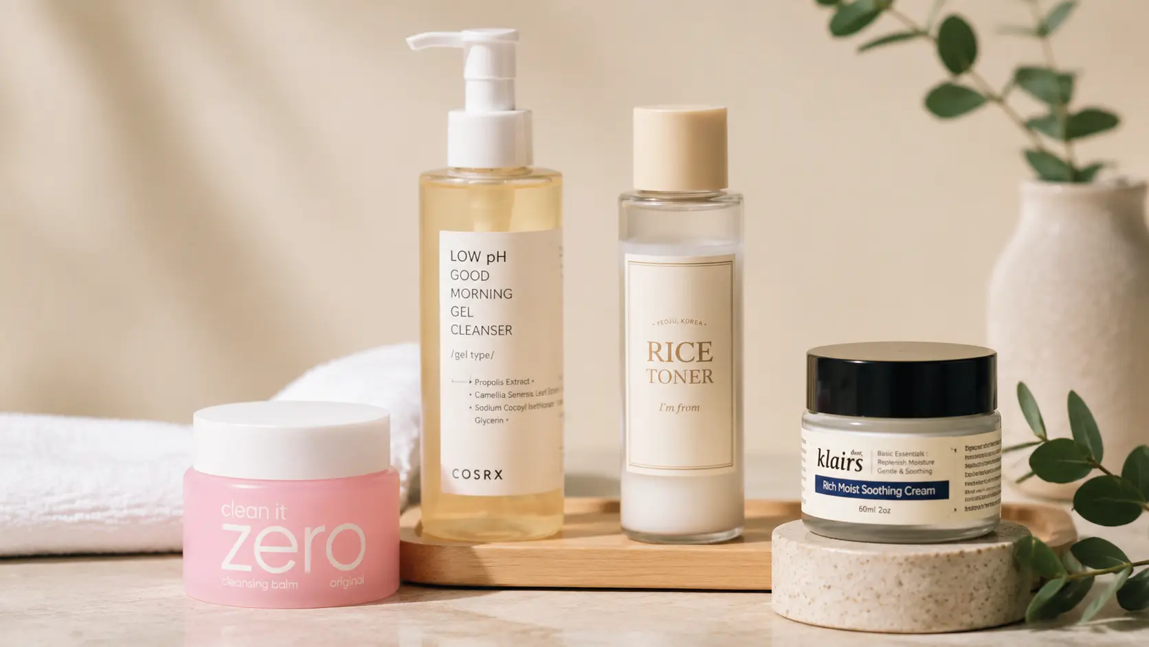 Korean skincare products featuring cleanser, rice toner and moisturizer arranged in a soft beige setting for routine care