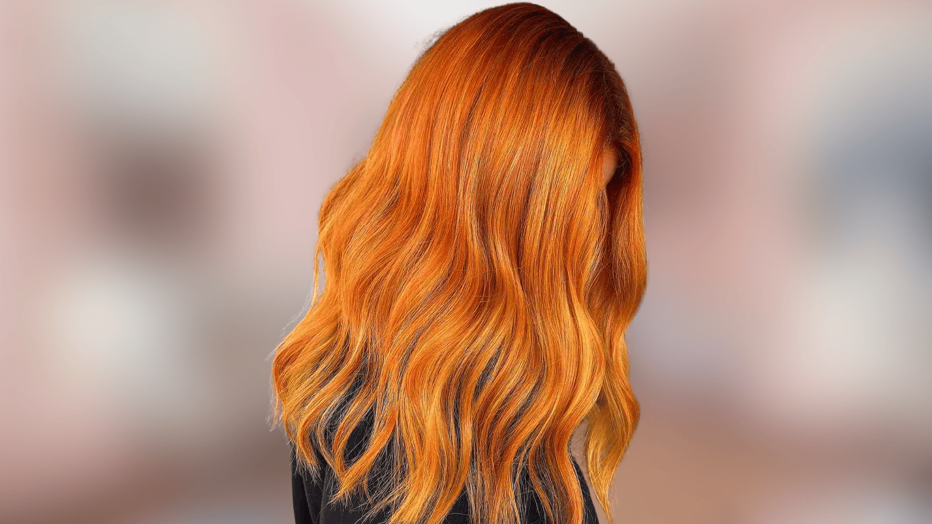 Shoulder length wavy hair displaying bright copper shade with vivid warm tones