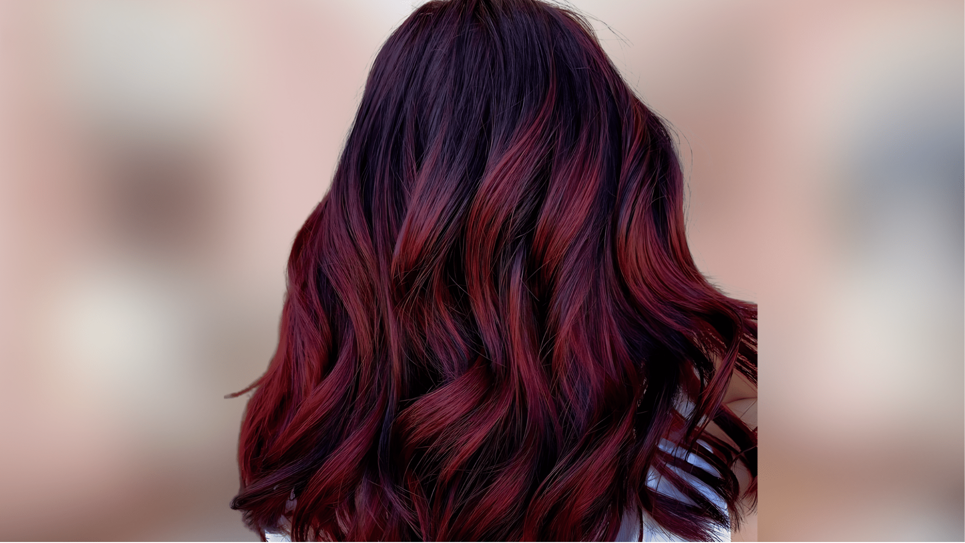 Shoulder length waves showing dramatic burgundy red hair with deep purple undertones