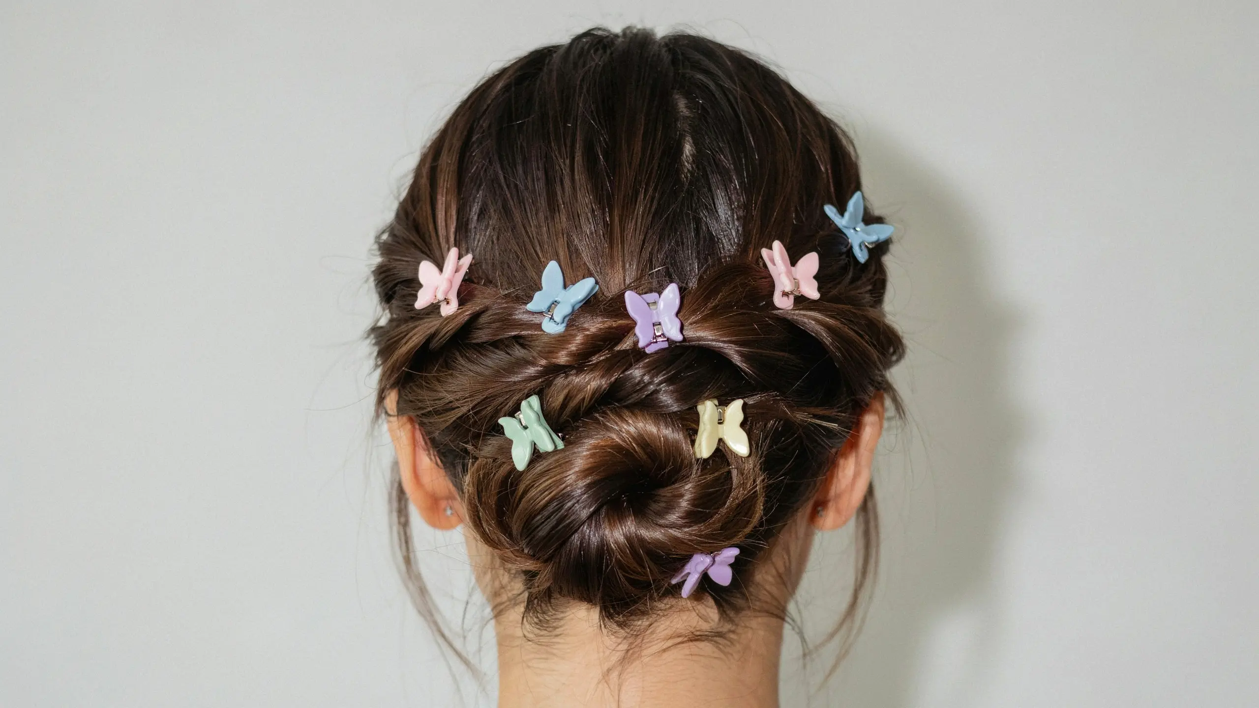 Butterfly clip braided bun styled among trendy updo hairstyles