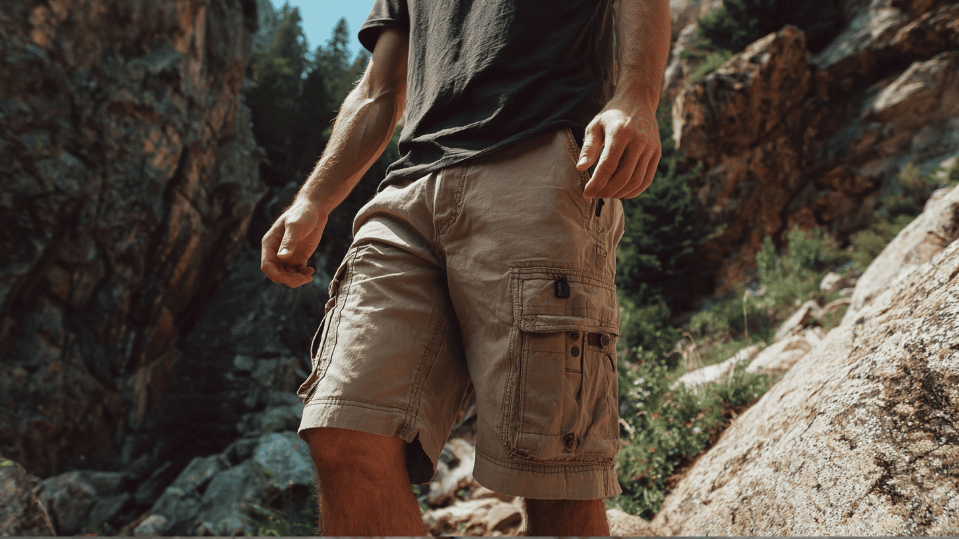 Man wearing olive green cargo shorts with multiple utility pockets for a casual outdoor outfit.