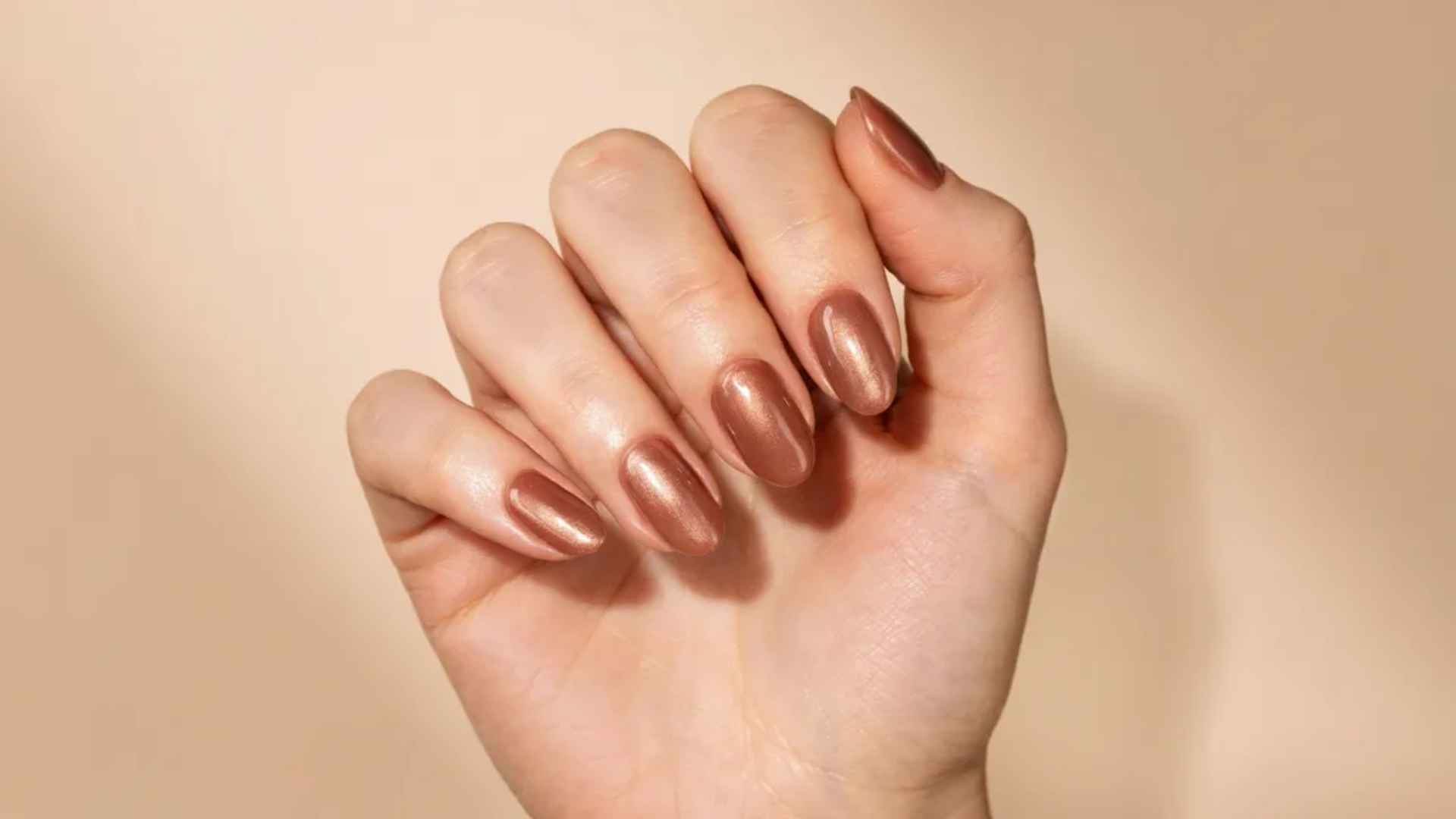 Close up of chocolate glazed donut nails with warm cocoa polish and a smooth reflective chrome finish in soft light 9. Glazed Donut Coffin Nails
