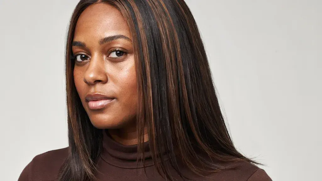 Dark brown straight hair with subtle caramel highlights styled in a sleek layered cut with smooth texture and natural shine