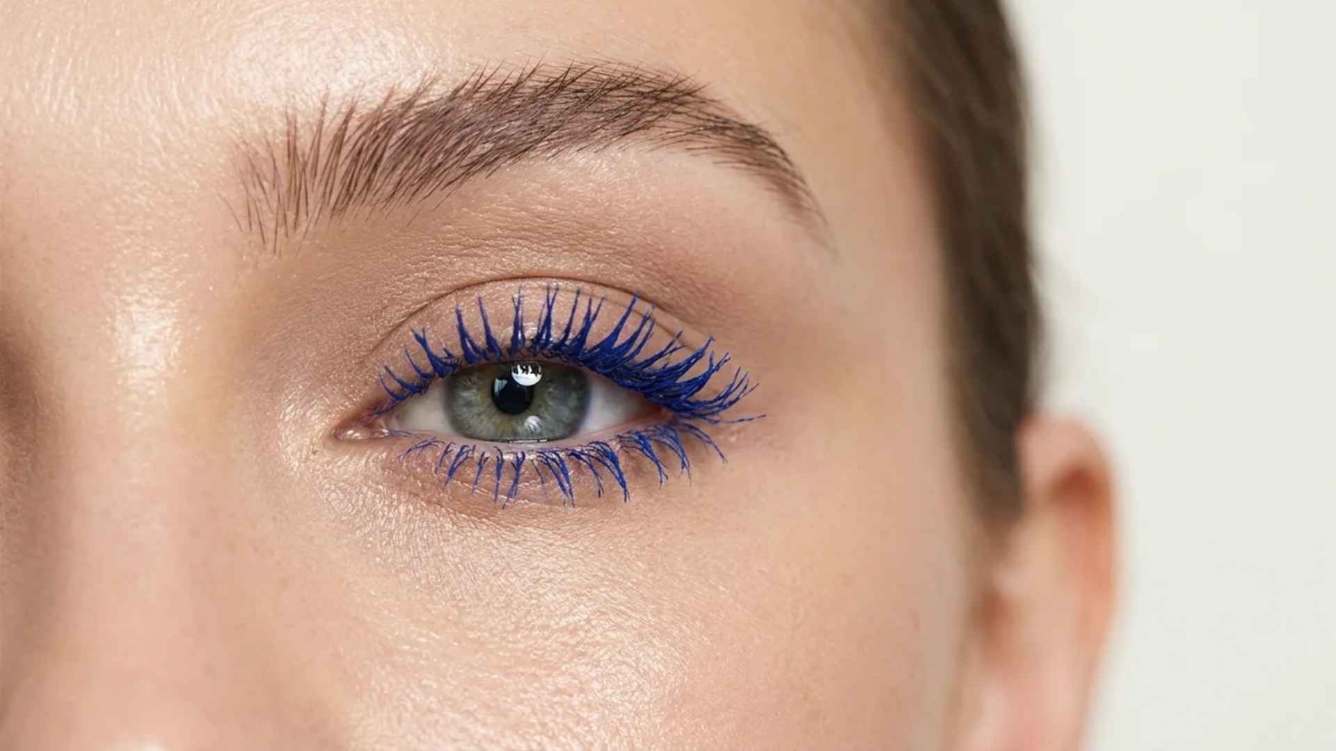 Blue mascara coated lashes with full volume, dramatic pigmented finish