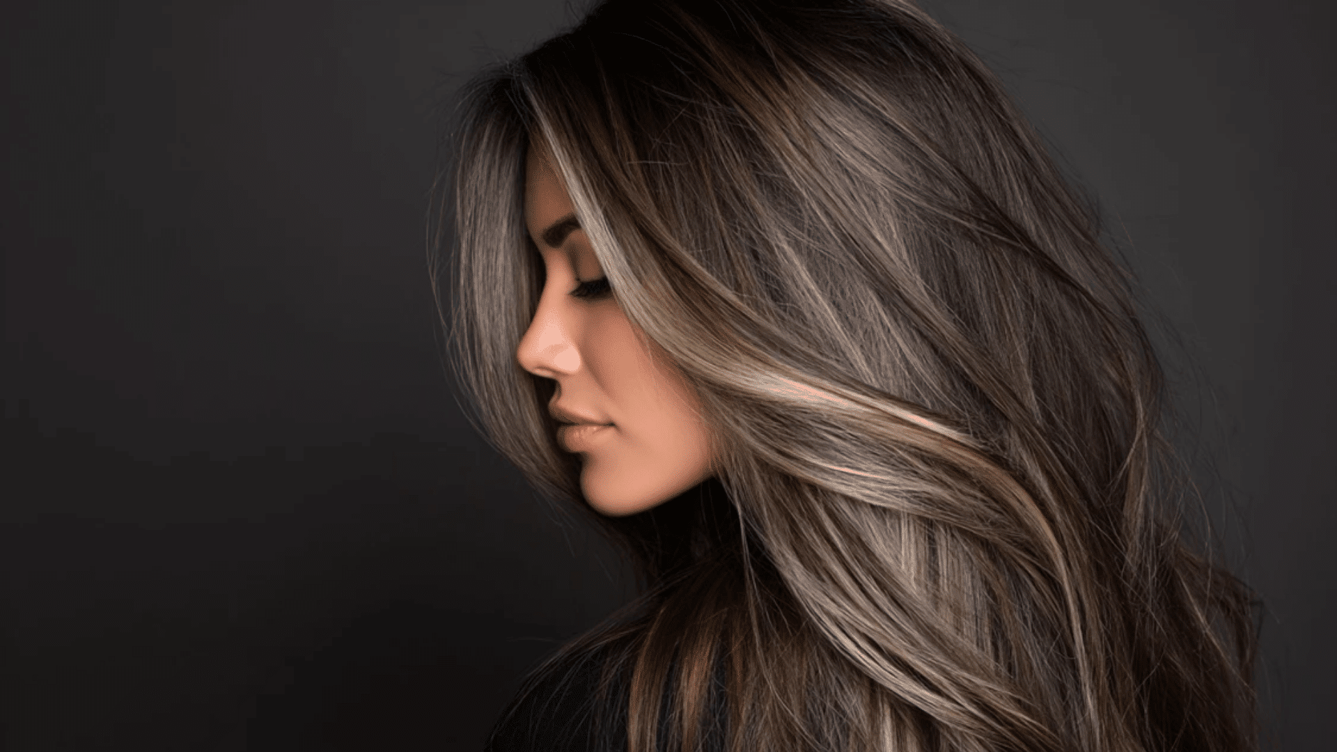 Cool-toned ombré balayage fading from dark roots to ashy brown ends