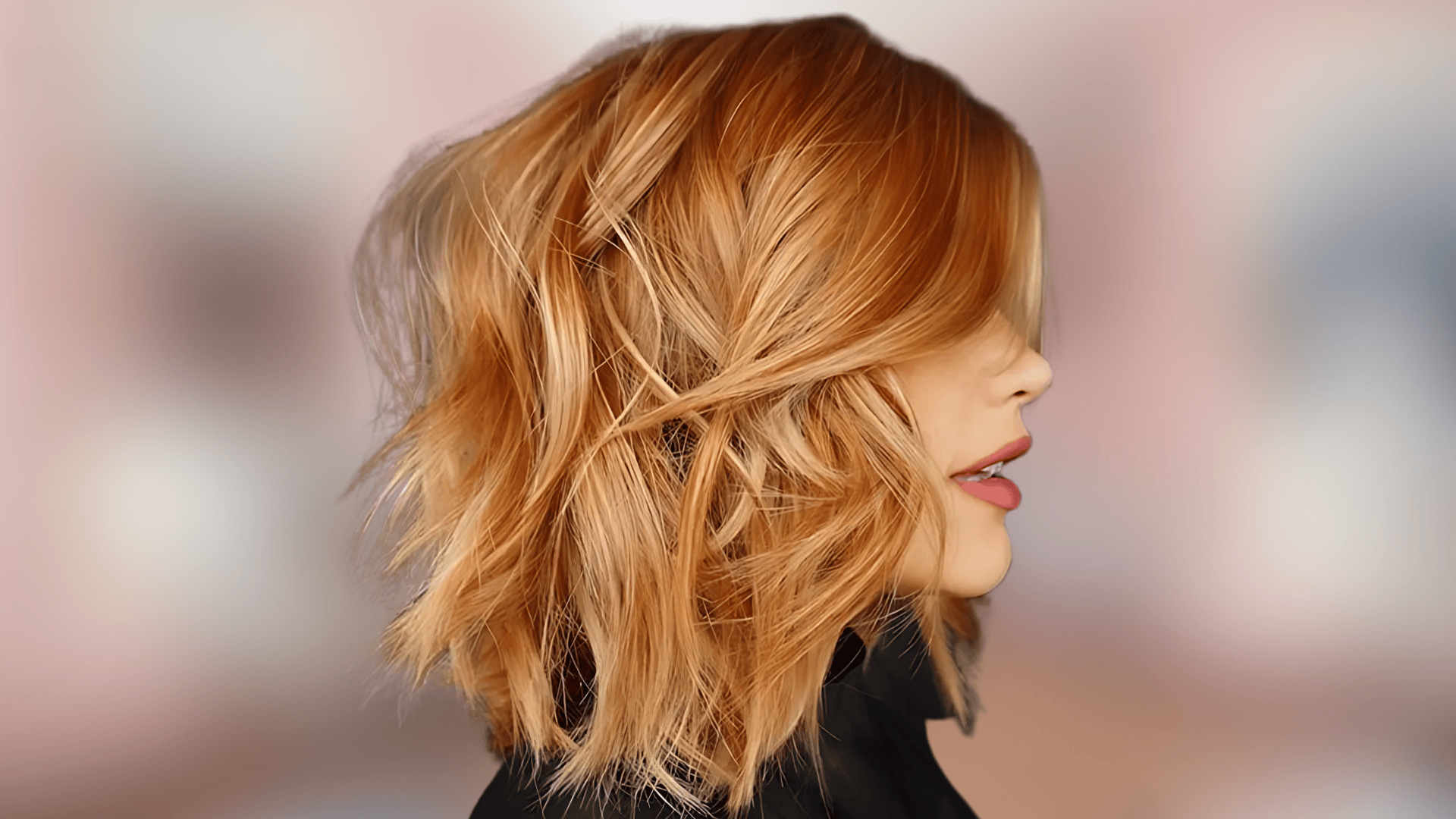 Shoulder length waves displaying copper blonde hair color with bright warm tones