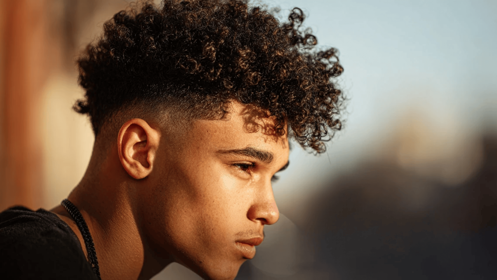 Curly top fade haircut highlighting natural curls and texture