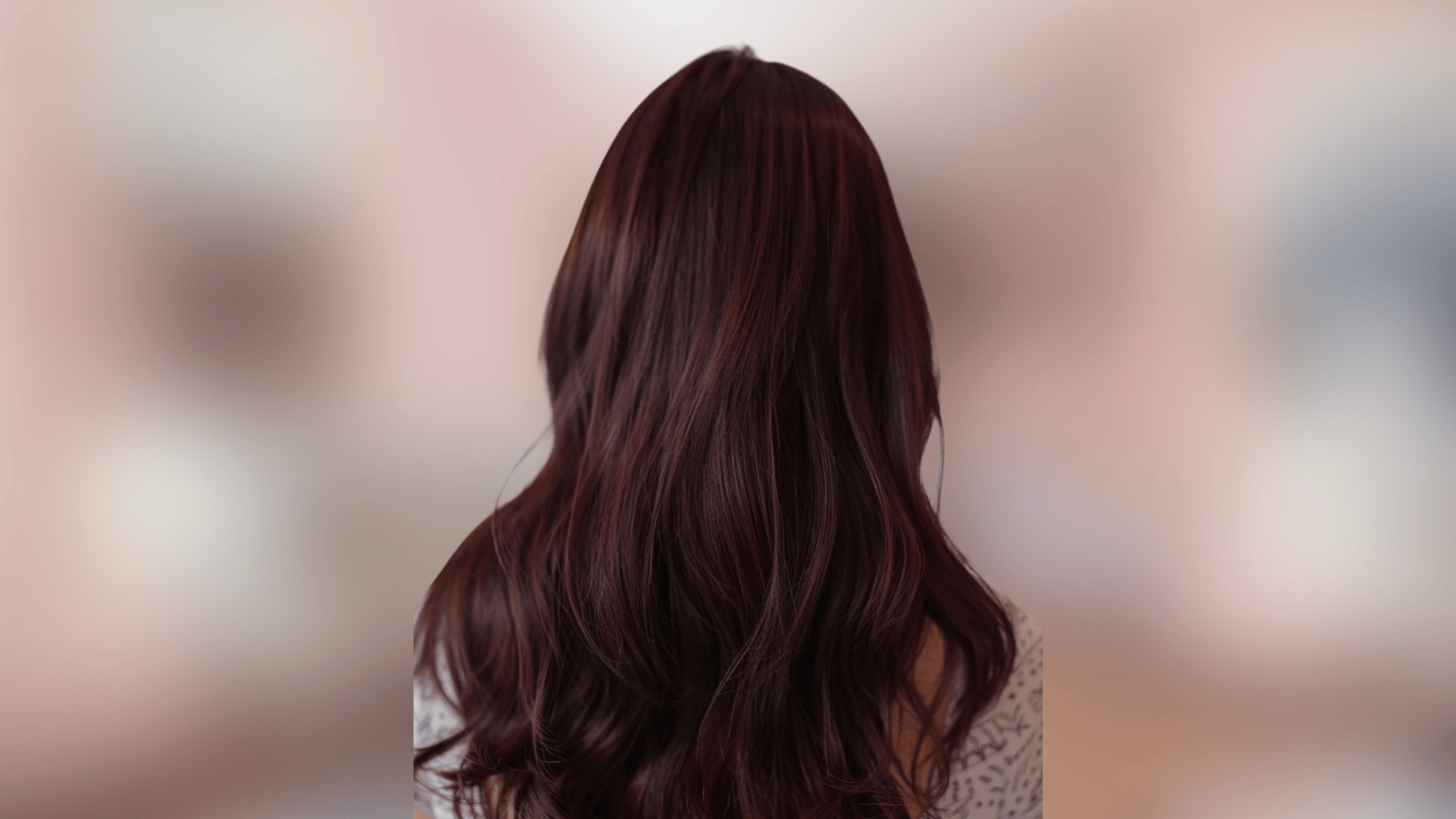 Soft wavy hairstyle featuring dark chocolate cherry hair with rich red tones