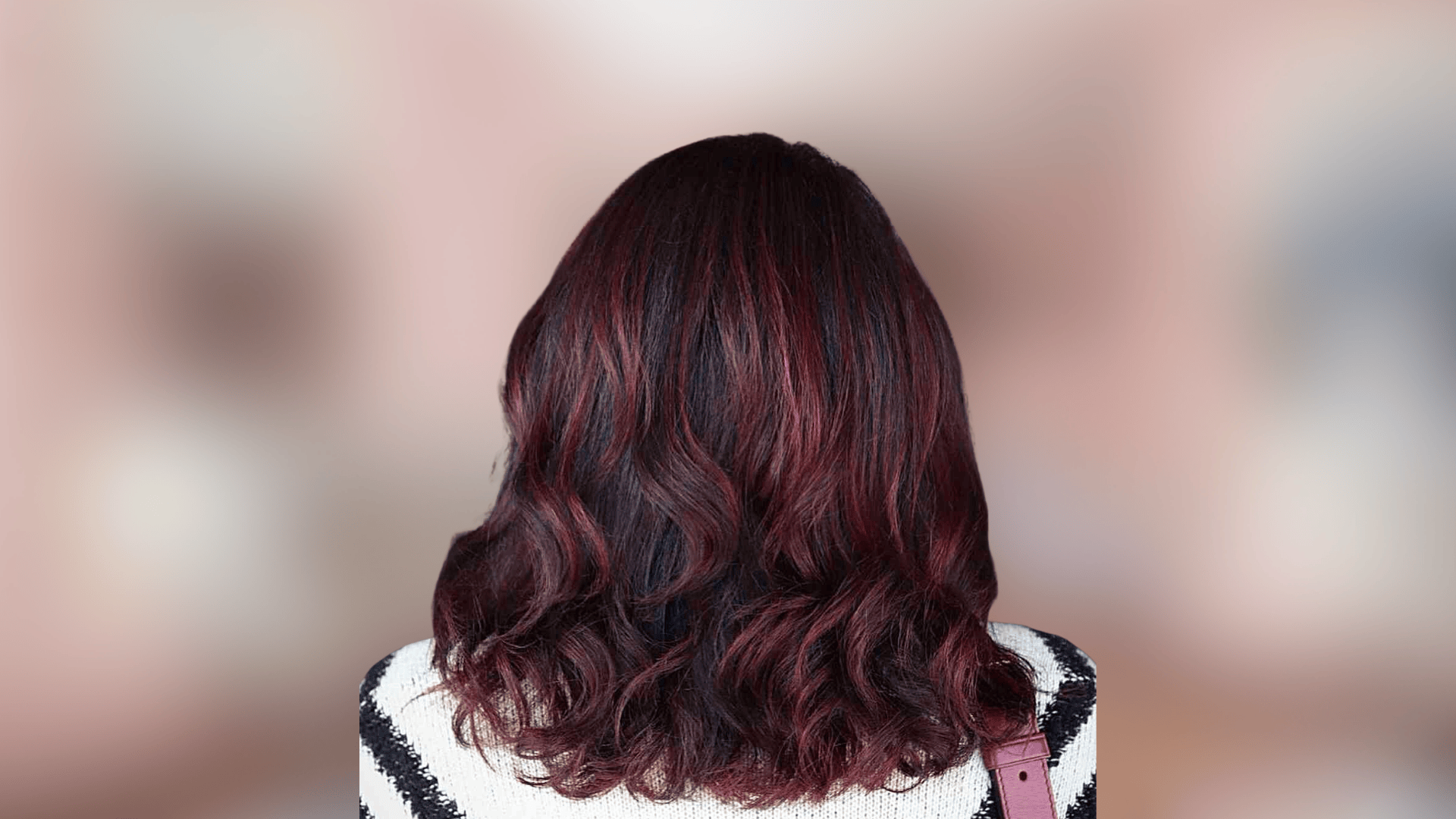 Shoulder length waves displaying dark mahogany hair color with rich warm depth
