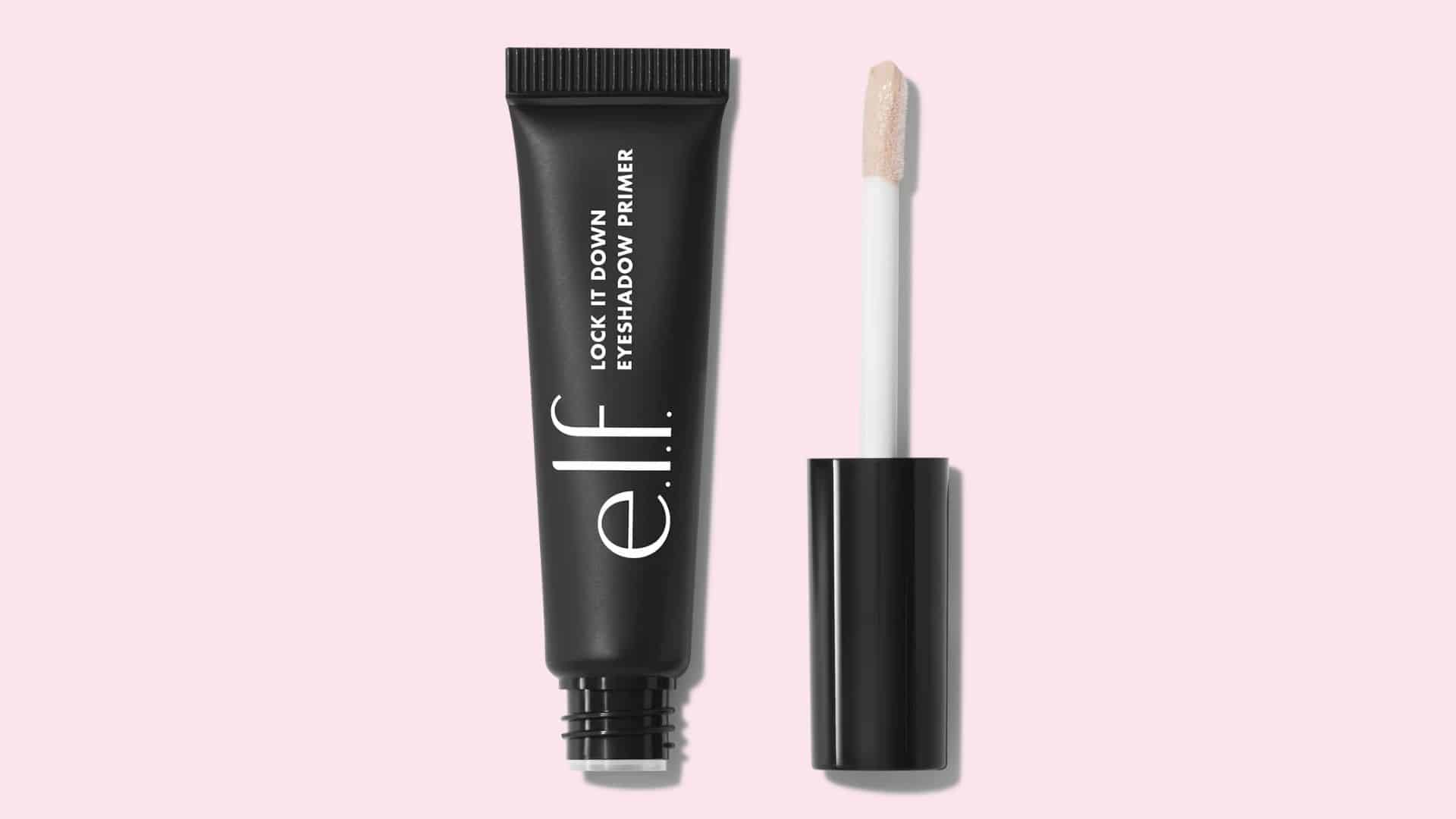 e.l.f. Lock It Down eyeshadow primer tube and applicator on a light pink background