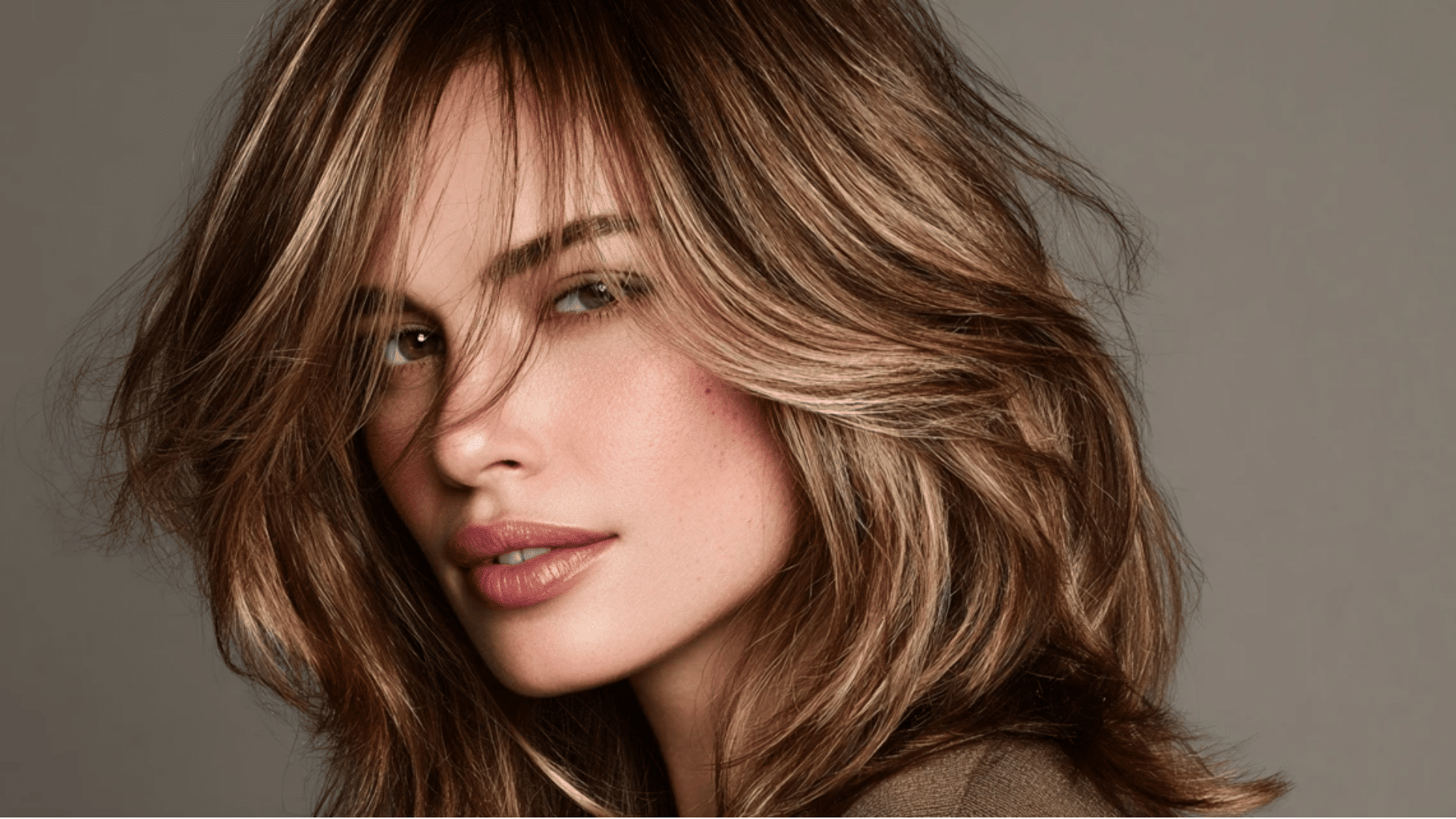 Feathered ash brown highlights on layered hair for natural movement