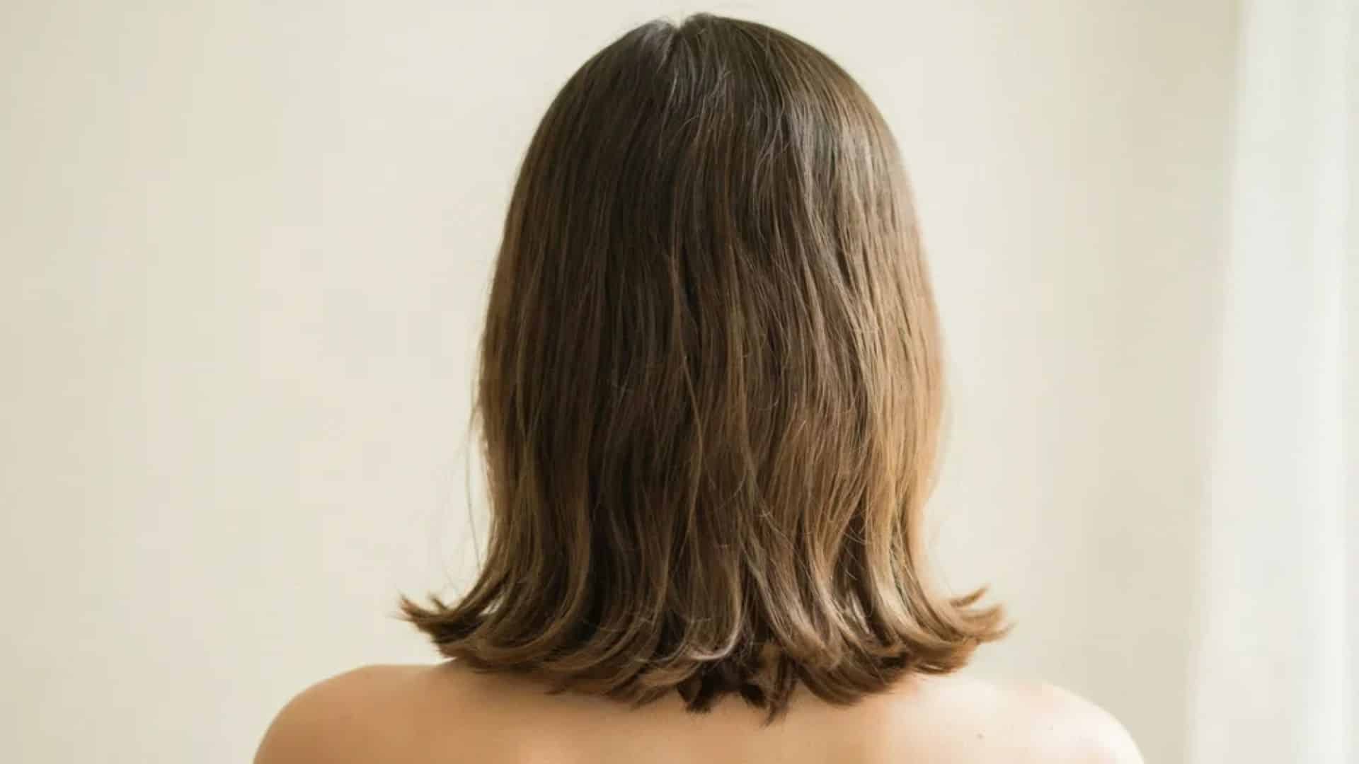 Y2K hairstyle with smooth straight hair and outward flipped ends for added movement.