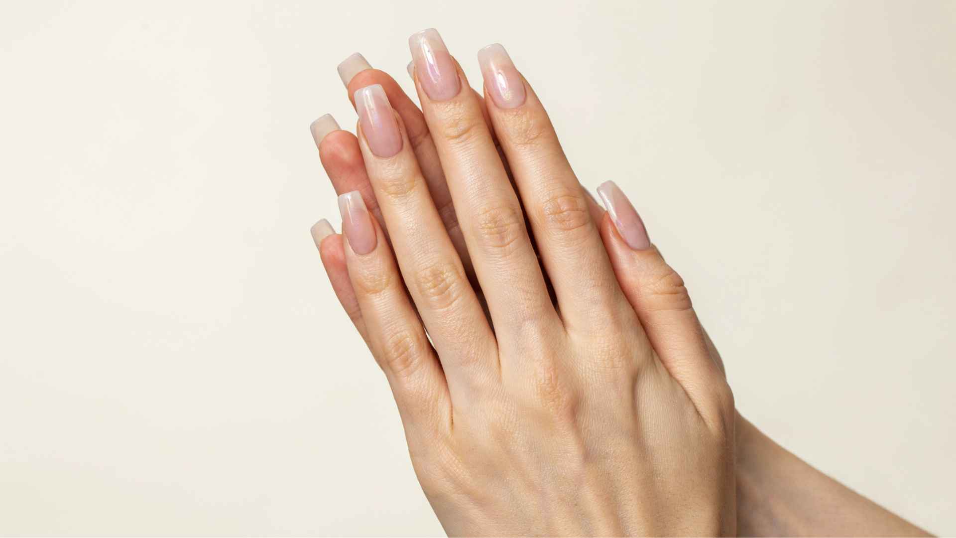 Close up of long coffin glazed donut nails with tapered sides, square tips, and a soft pearly chrome glow in daylight