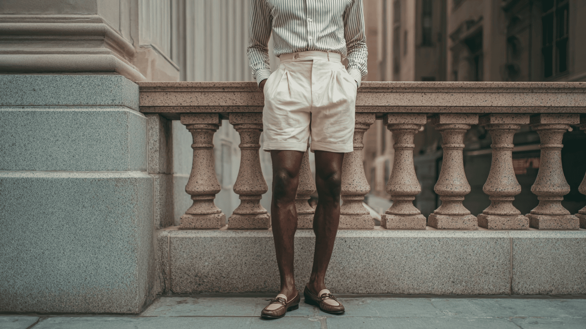 Man wearing high waist shorts with a tucked in shirt for a vintage inspired style.