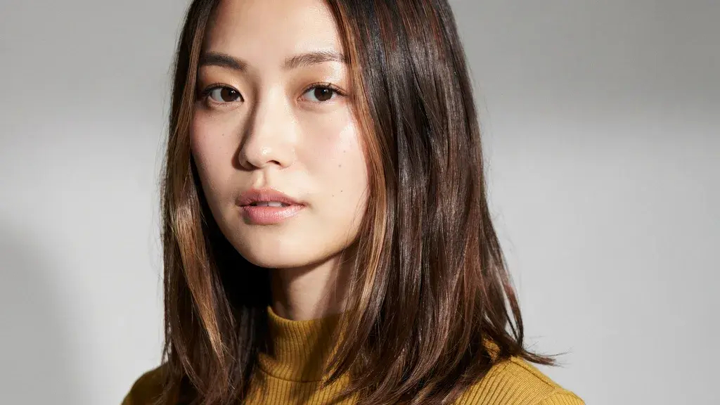 Dark brown hair with subtle warm highlights styled in a sleek straight layered cut with smooth shine and texture