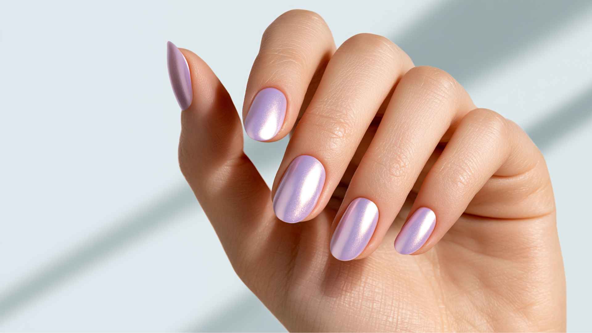 Close up of lavender glazed donut nails with a soft pastel base and delicate pearl chrome shine in natural light