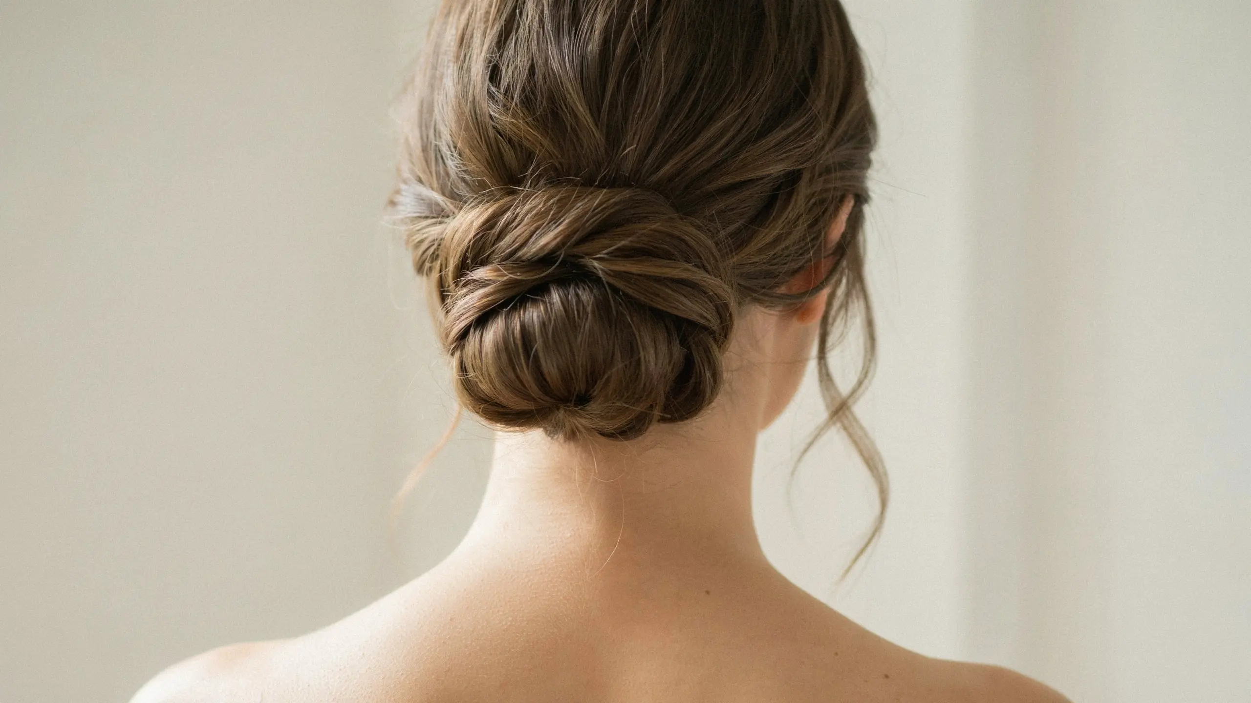 Low chignon styled into soft, textured updo hairstyles