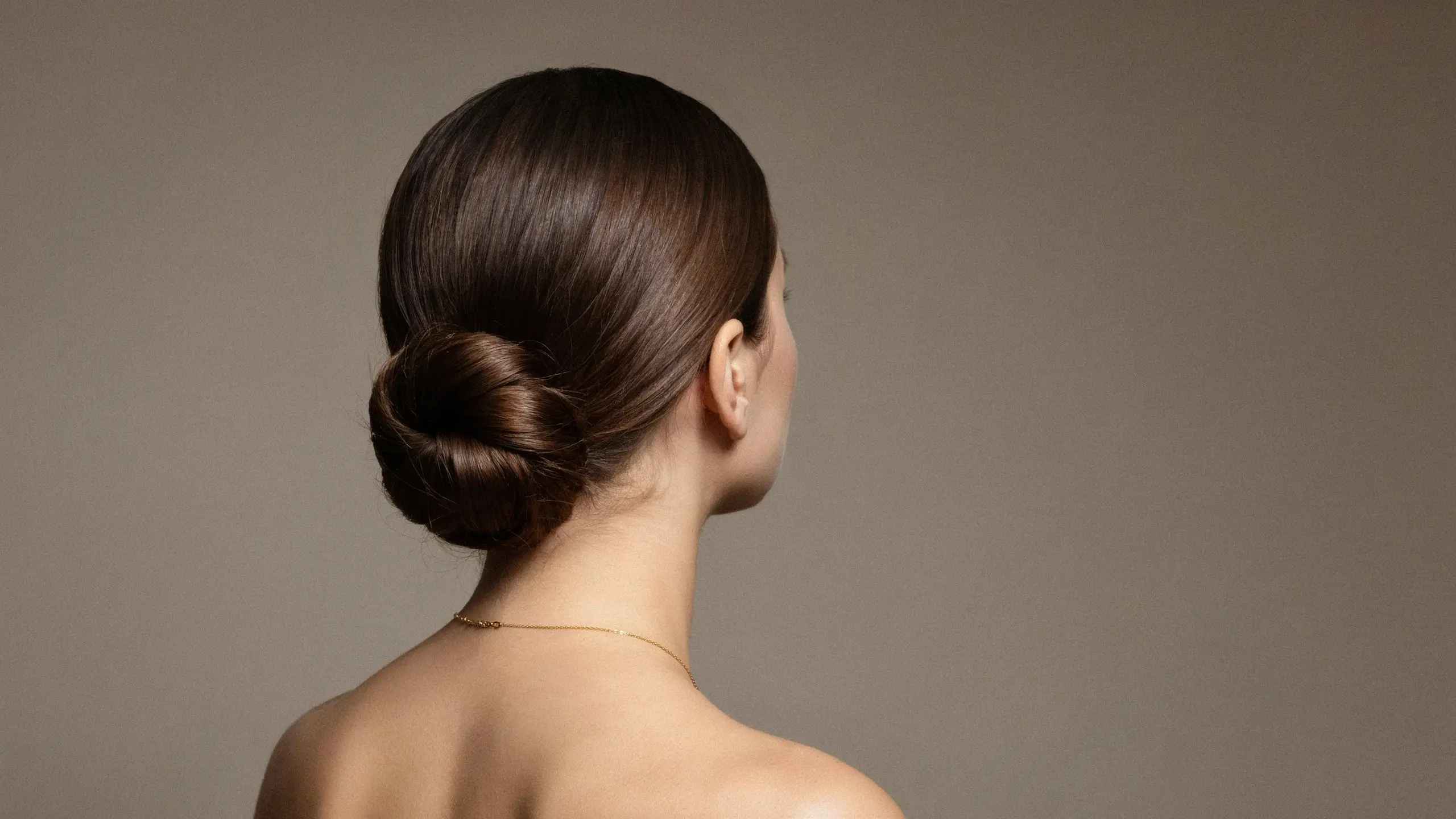 Low sleek bun styled among polished, elegant updo hairstyles
