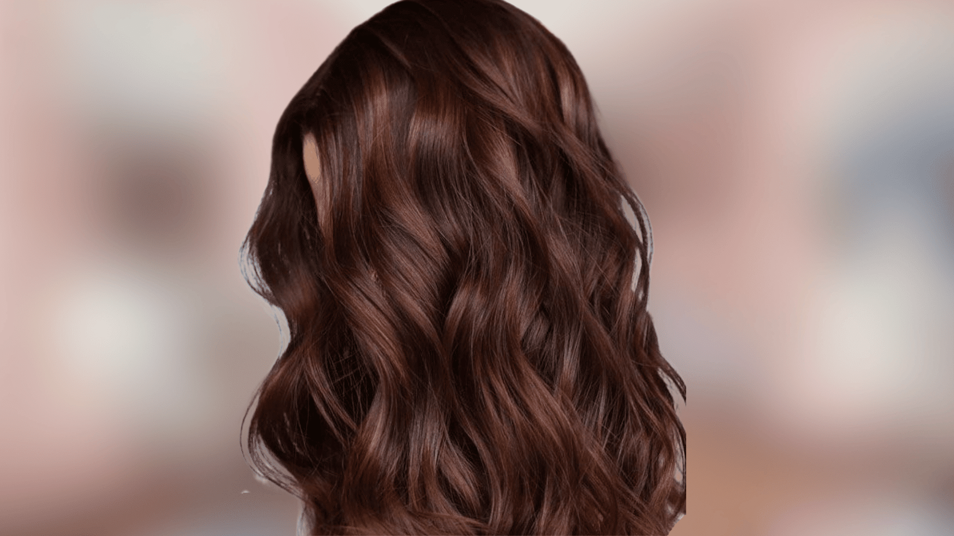 Shoulder length waves displaying mahogany chestnut hair color with warm depth