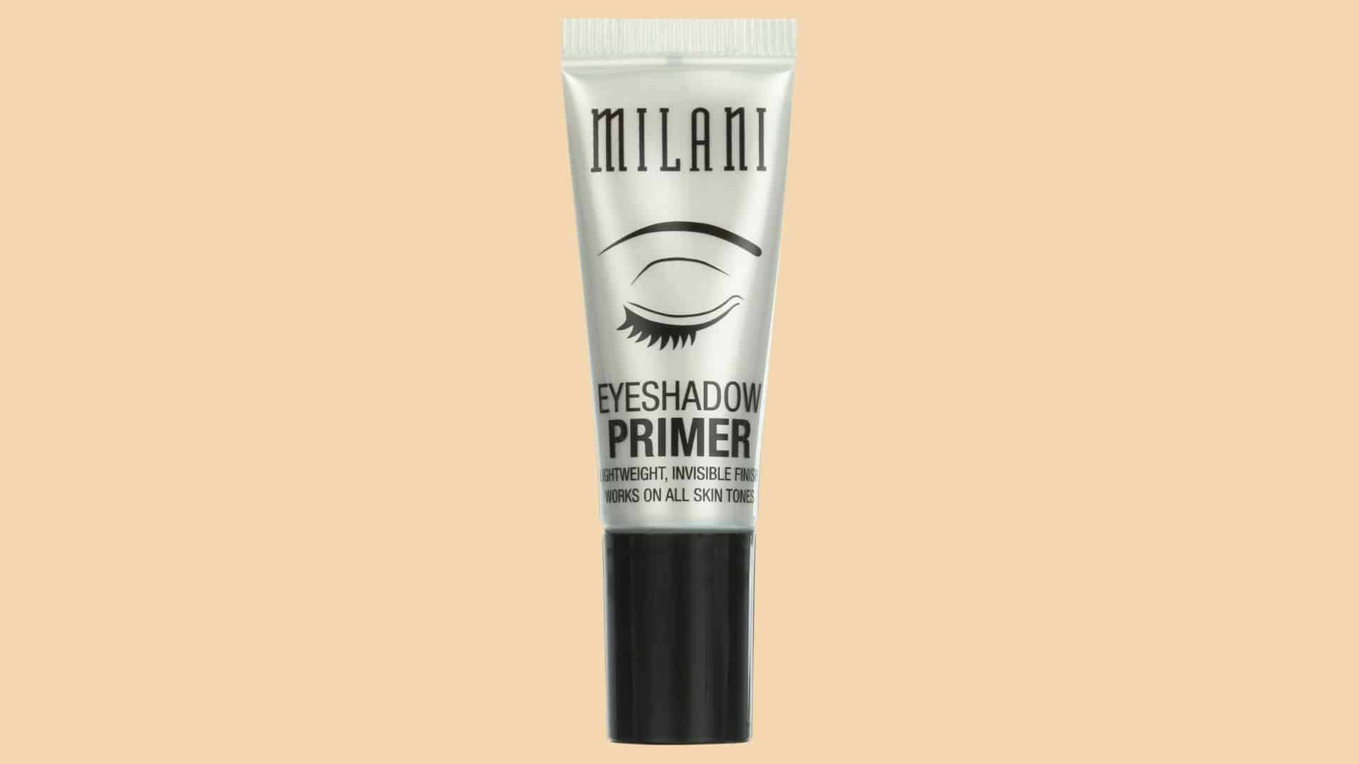 Milani Eyeshadow Primer tube with eye design packaging on a beige background