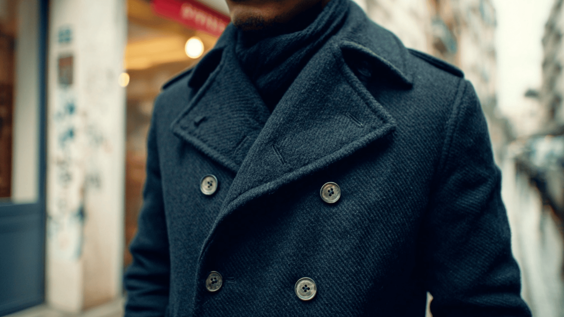 Navy wool peacoat with double breasted buttons and classic winter styling