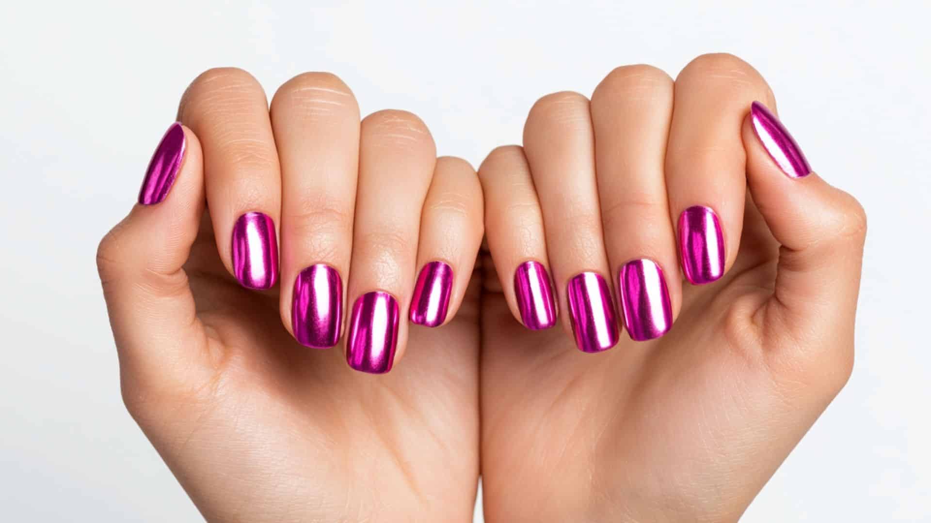 Hot pink chrome nails with a mirror like metallic shine