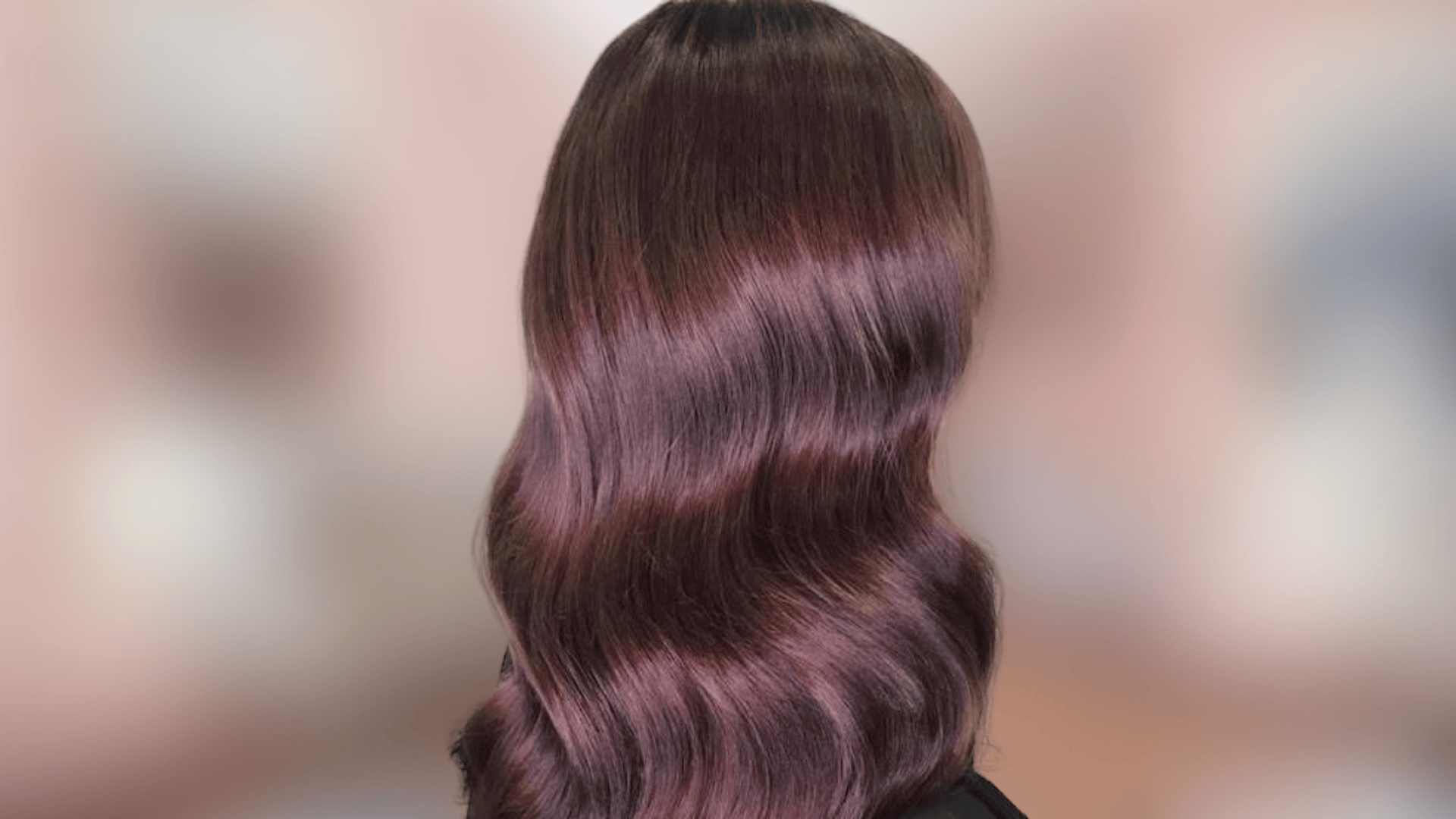 Shoulder length waves showing plum brown hair color with cool purple undertones