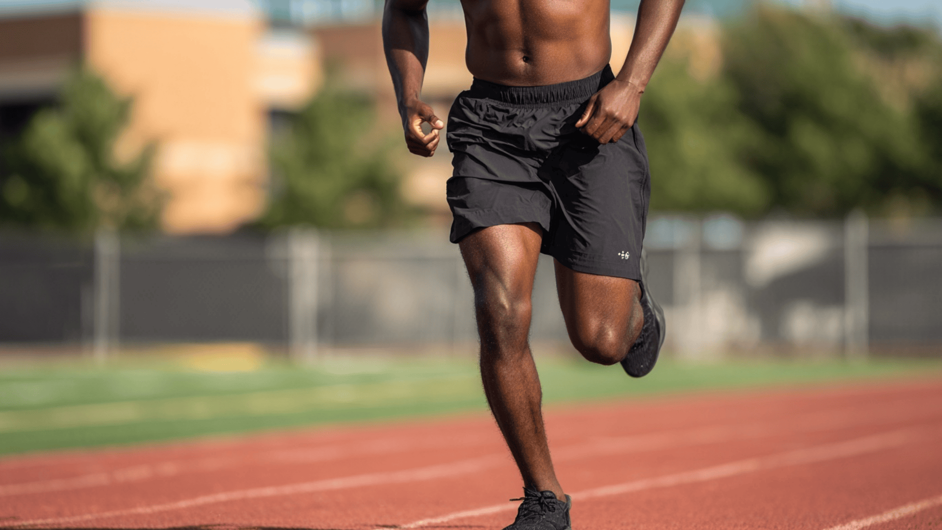 Man wearing lightweight running shorts with a tank top during an outdoor workout.