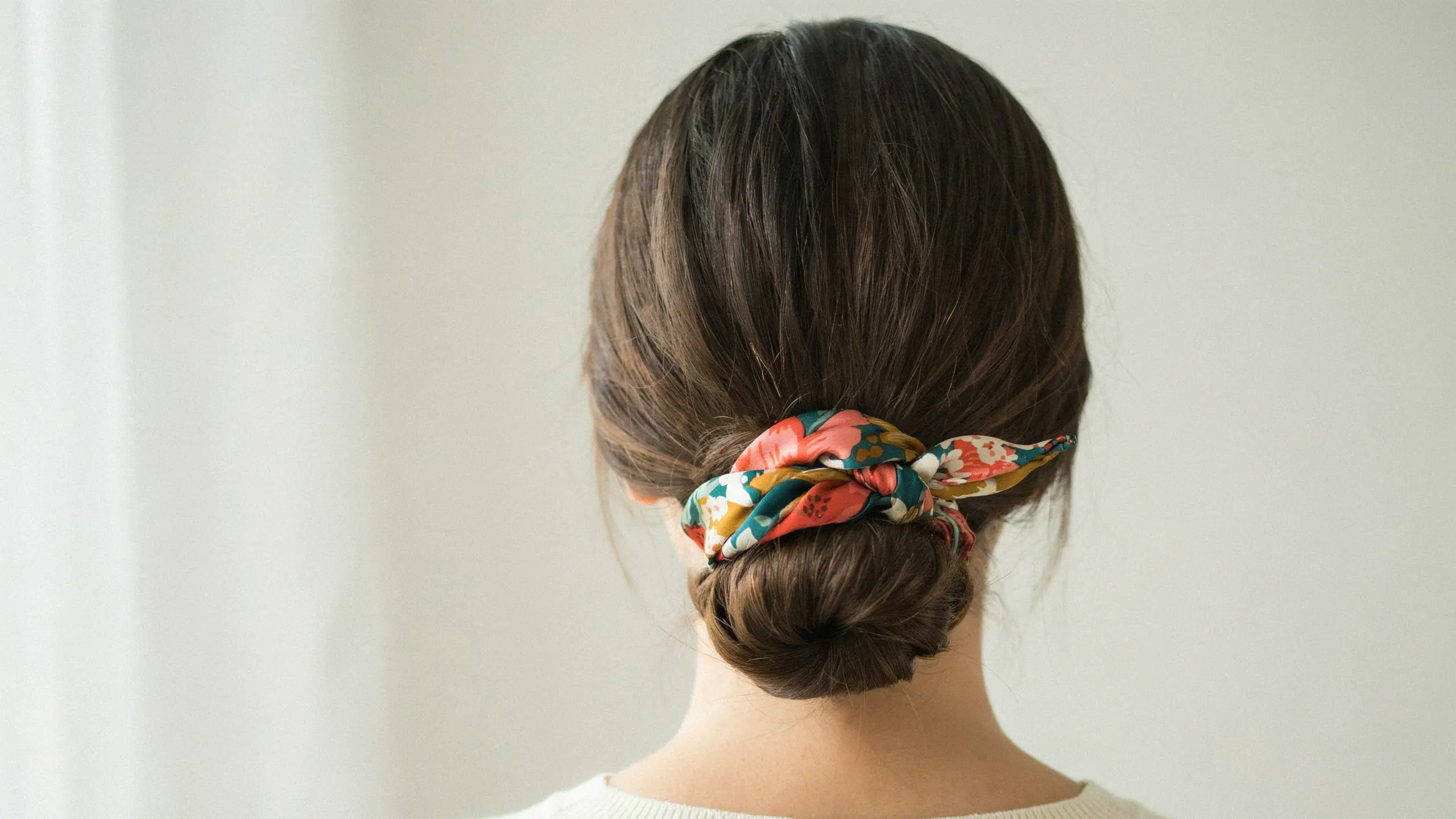 Scarf wrapped low bun, one of the cute updo hairstyles with accessories