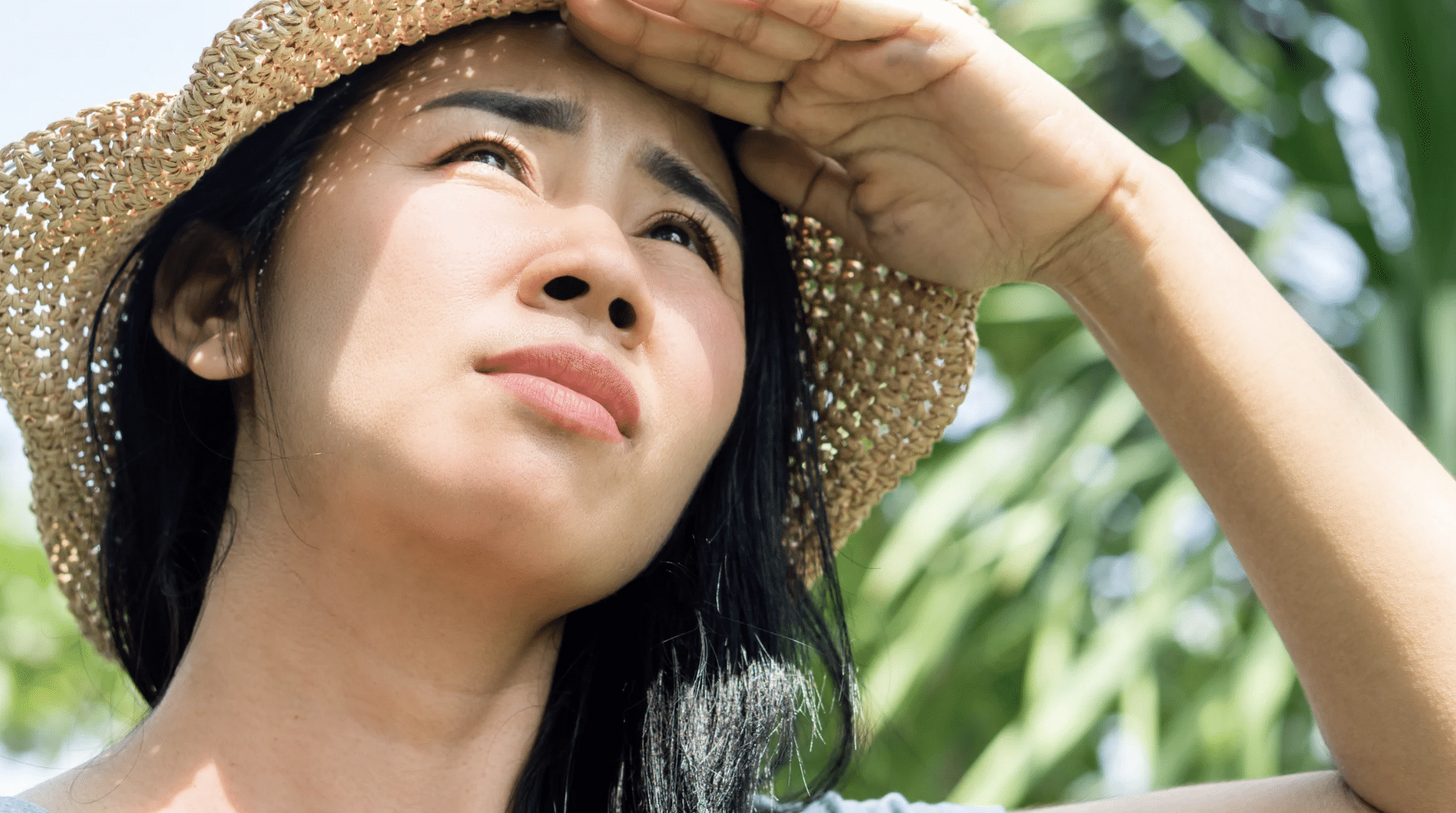 Woman with irritated red facial skin caused by environmental factors like sun exposure
