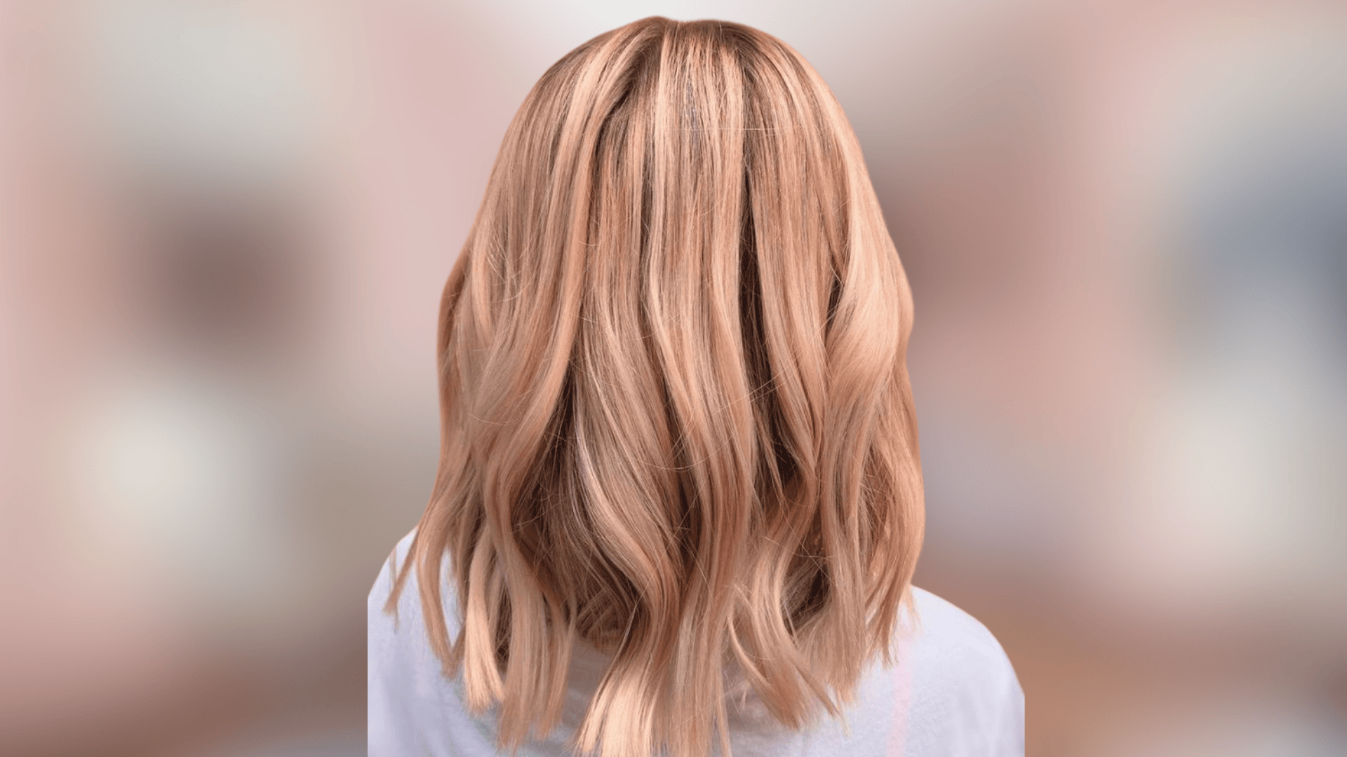 Shoulder length waves showing soft peach blonde shade with warm pastel tones