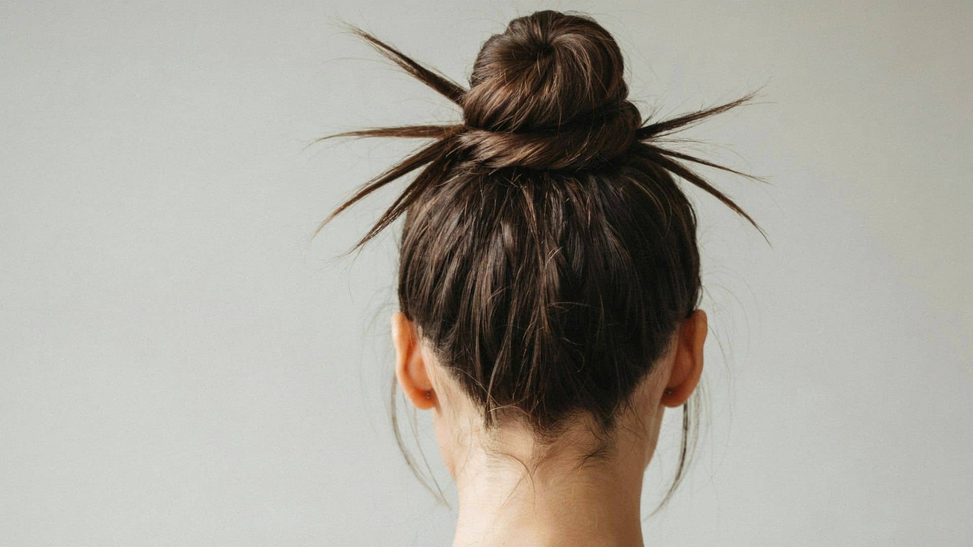 Early 2000s spiky bun hairstyle with textured pieces sticking out around the crown.