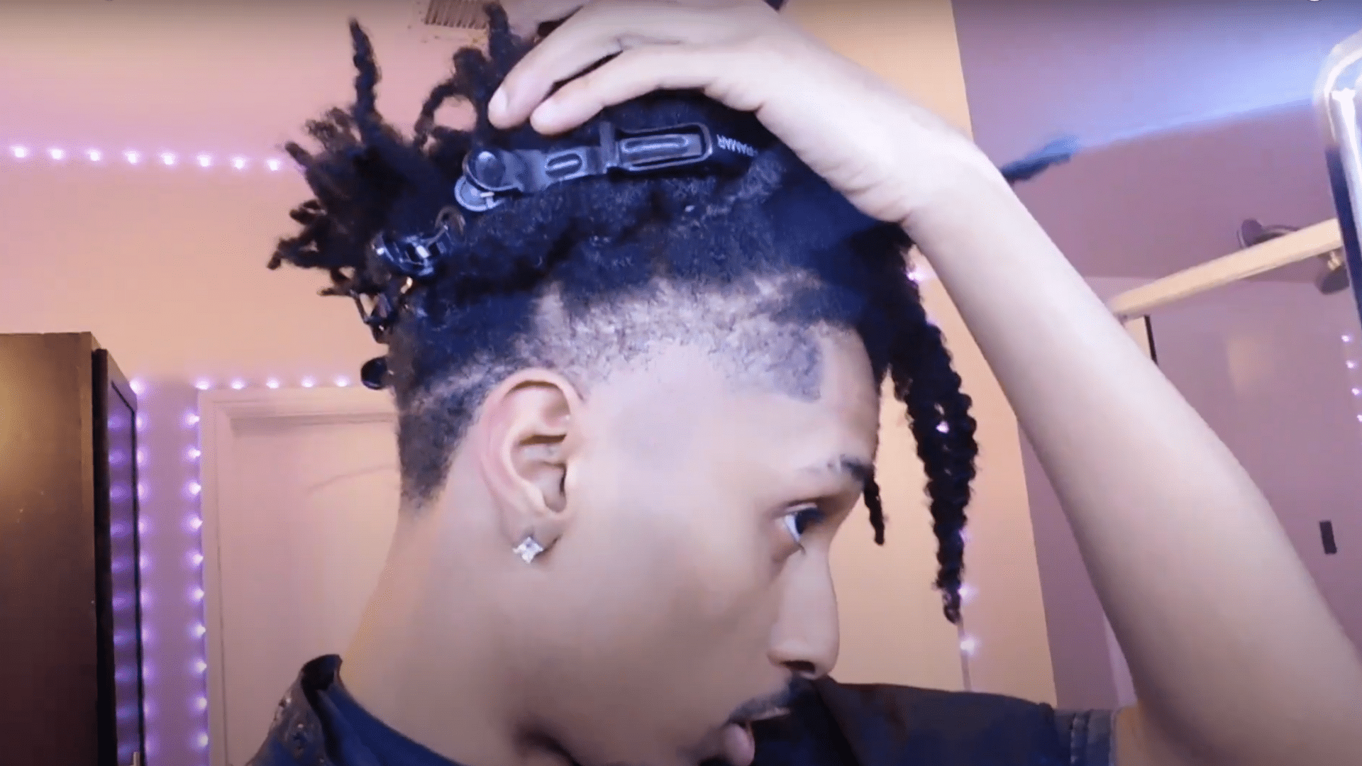 Separate hair with clips before creating a front taper section above the widow's peak for a clean haircut