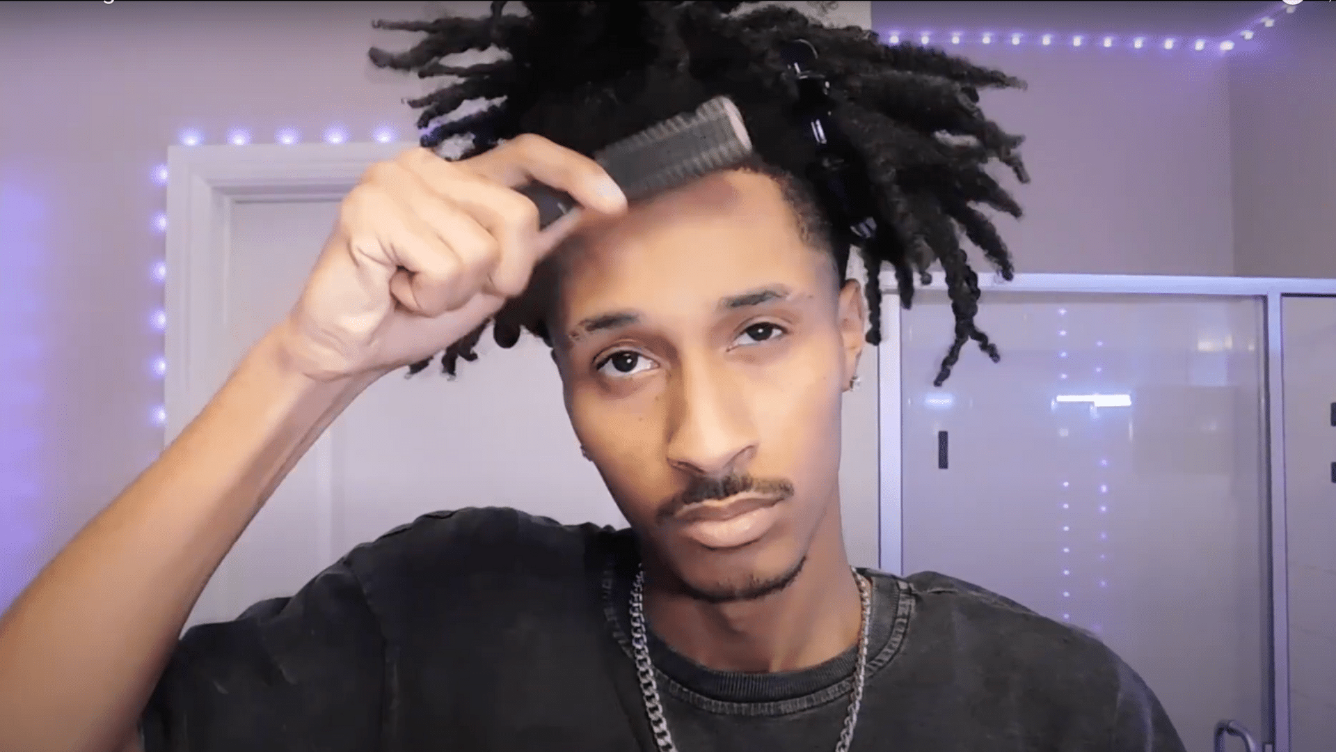 Twist the remaining locs back after finishing the front taper to blend the haircut with the rest of the hair