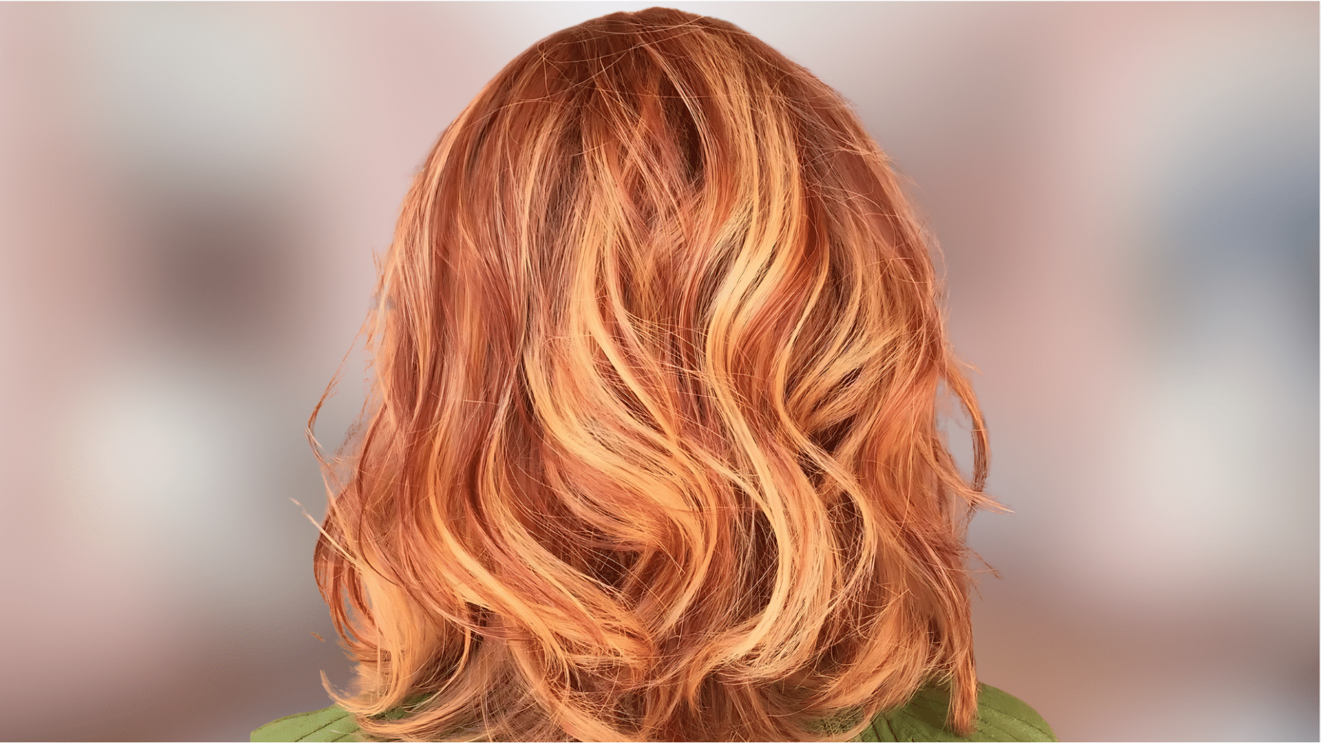 Soft wavy hair featuring strawberry blonde color with warm golden red tones