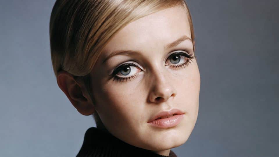 Twiggy inspired 60s makeup with bold crease liner, separated lashes, painted lower lashes, and pale pink lips