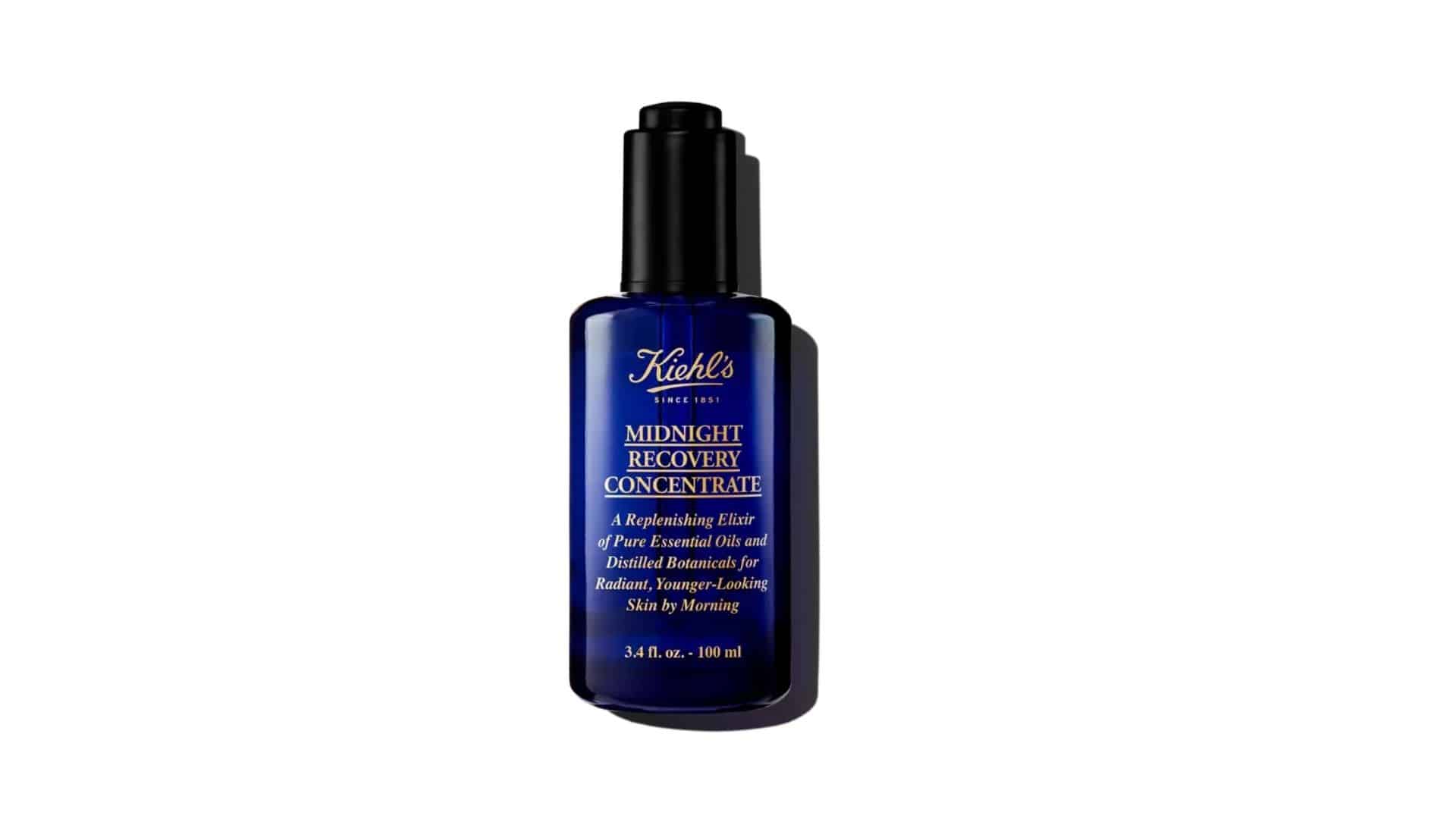 A blue glass bottle of Kiehl's Midnight Recovery Concentrate with a black cap.