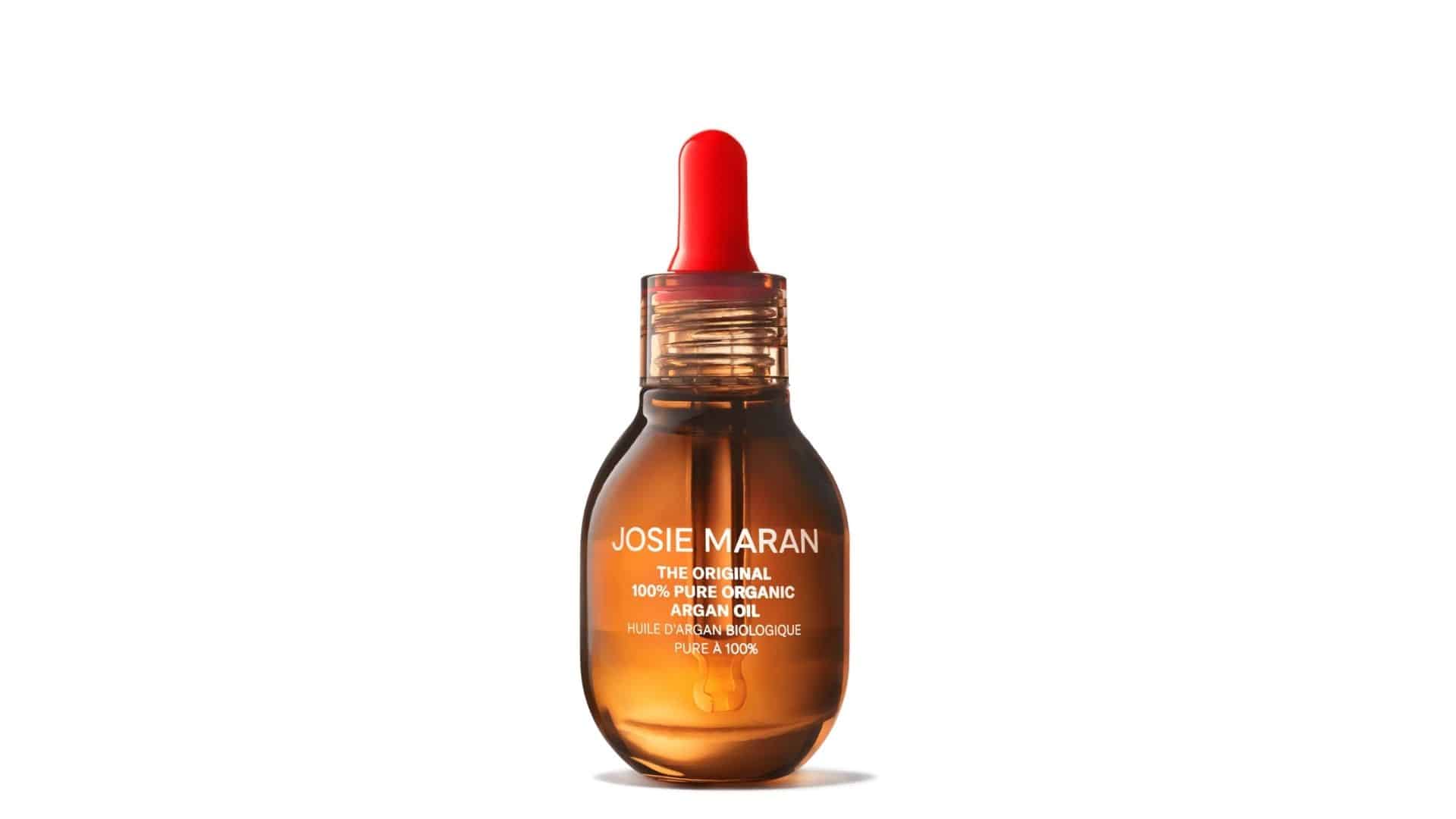 A bottle of Josie Maran 100% Pure Organic Argan Oil with a red dropper top.