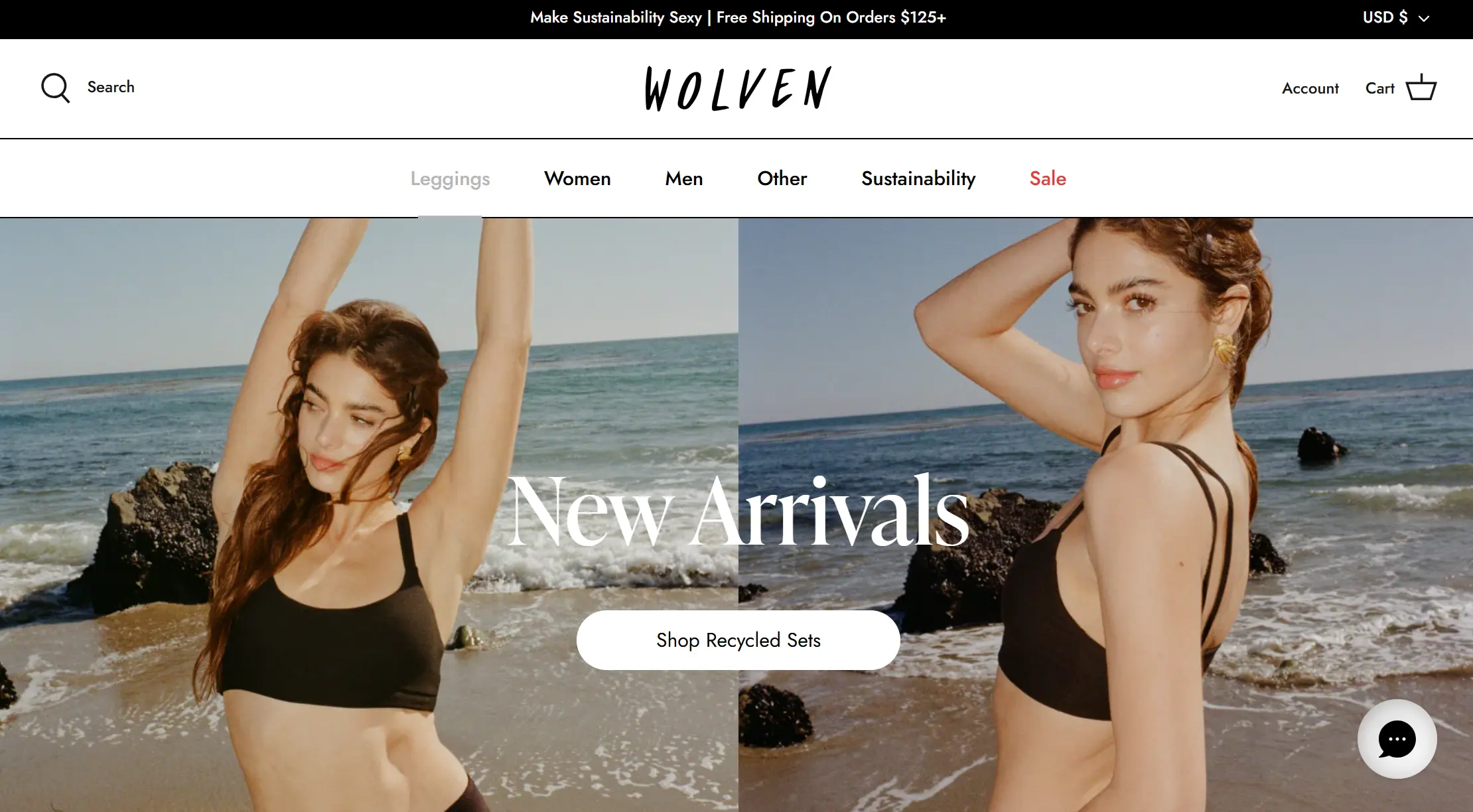 A woman posing in a black crop top on a beach with